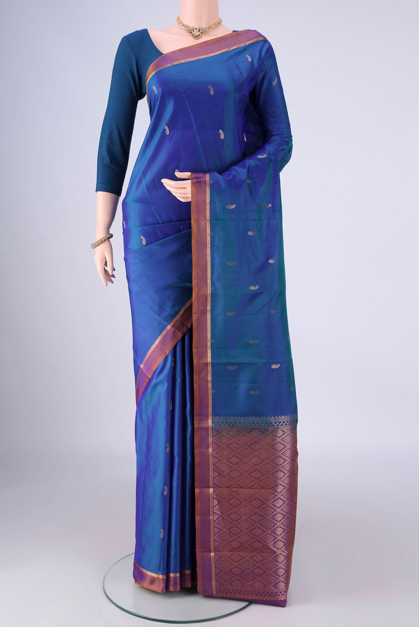 Peacock Blue Nangavalli Silk [ Salem ] Saree with Zari Butta on the body and Zari Border.  displayed on a mannequin