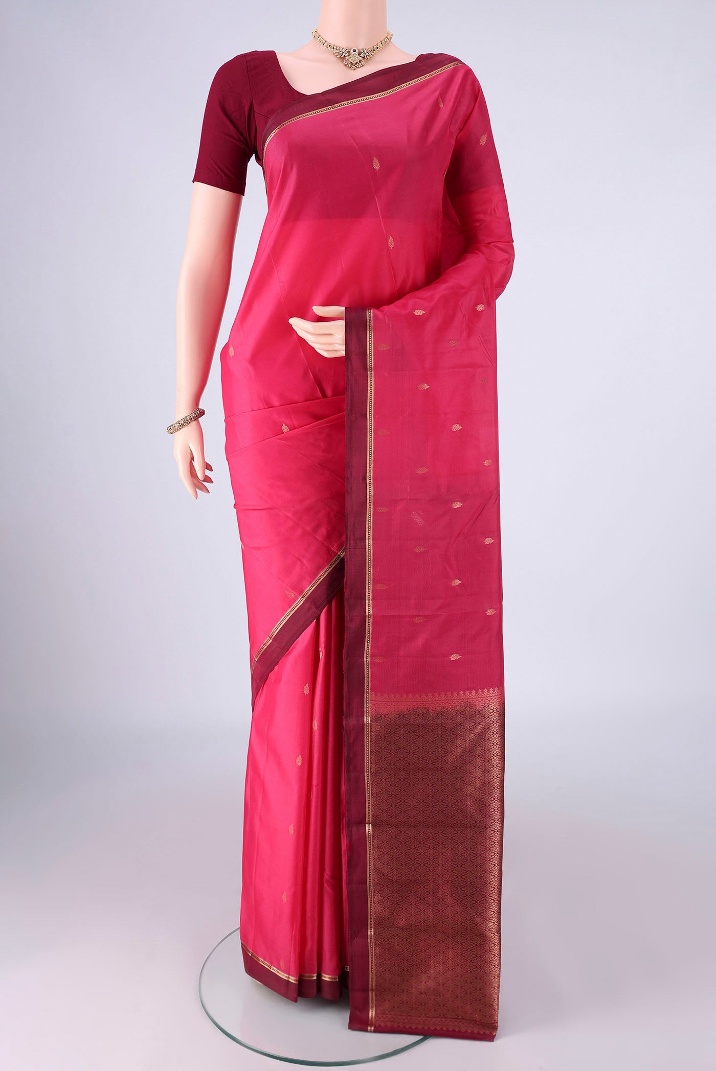 Pink Kanjivaram Silk Saree with Zari Butta on the body and Zari Border.  displayed on a mannequin