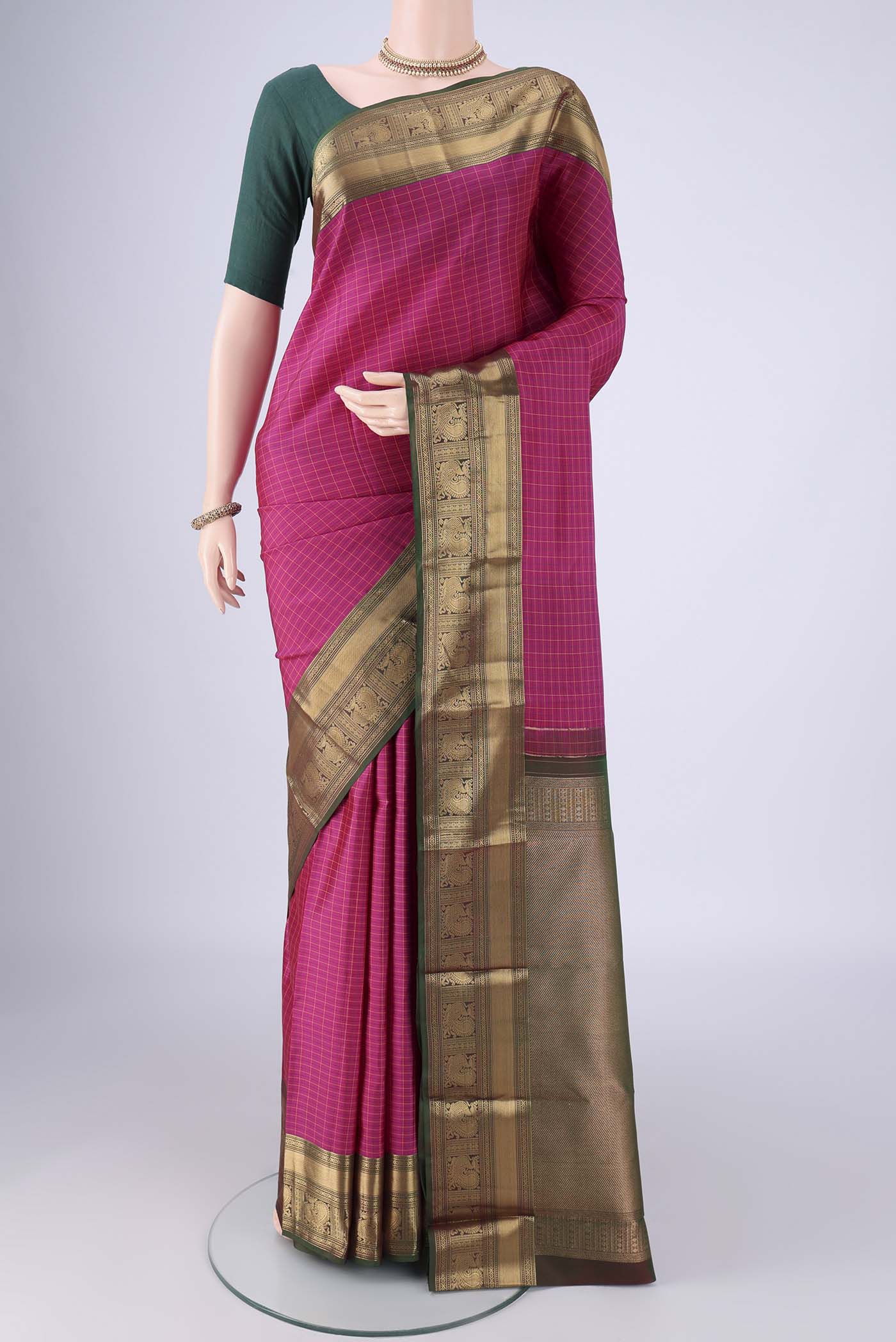 Rani Pink Kanchipuram Silk Saree with Checked design on the body and Zari Border.  displayed on a mannequin