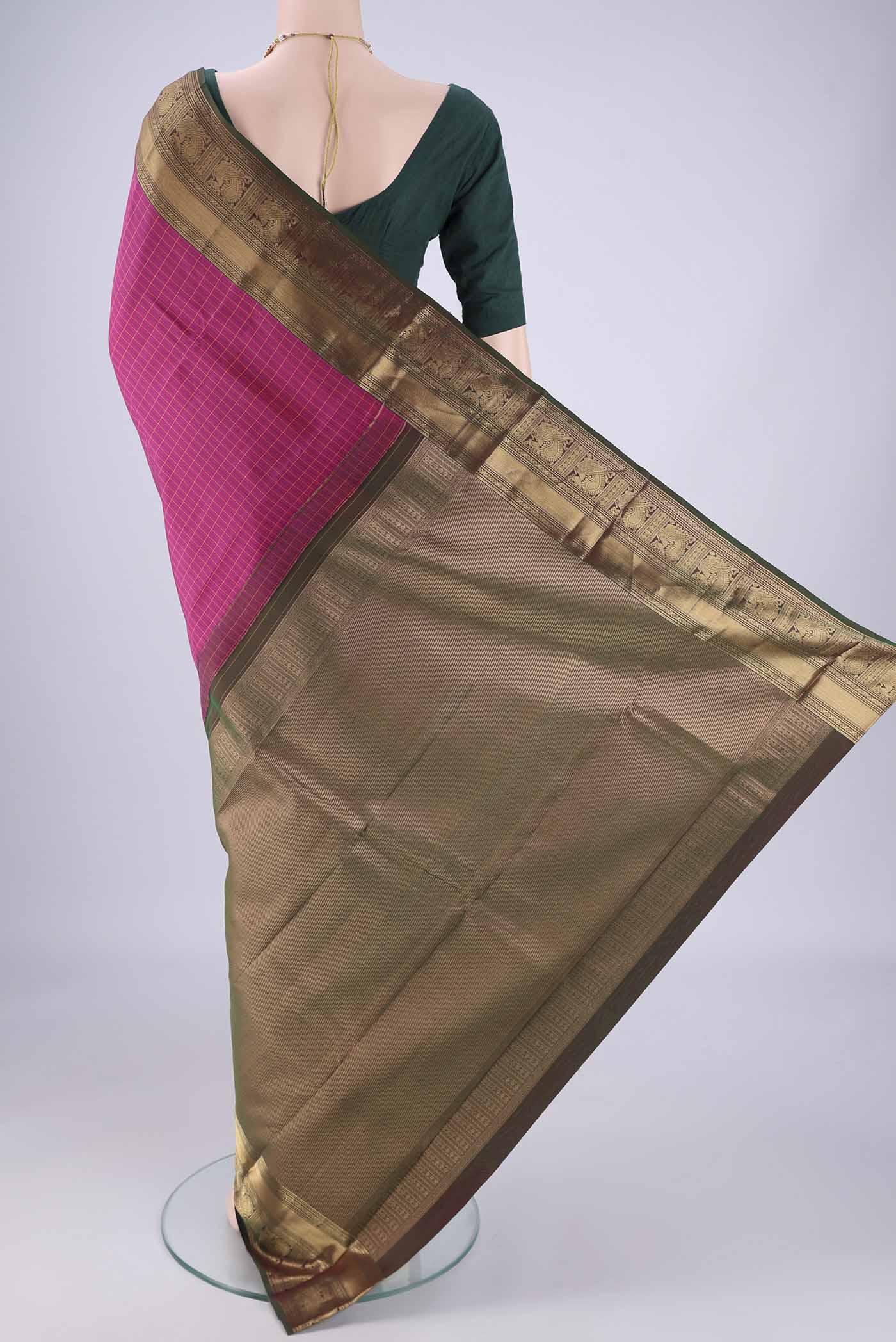 Flat view of Rani Pink Kanchipuram Silk Saree with Checked design on the body and Zari Border. 