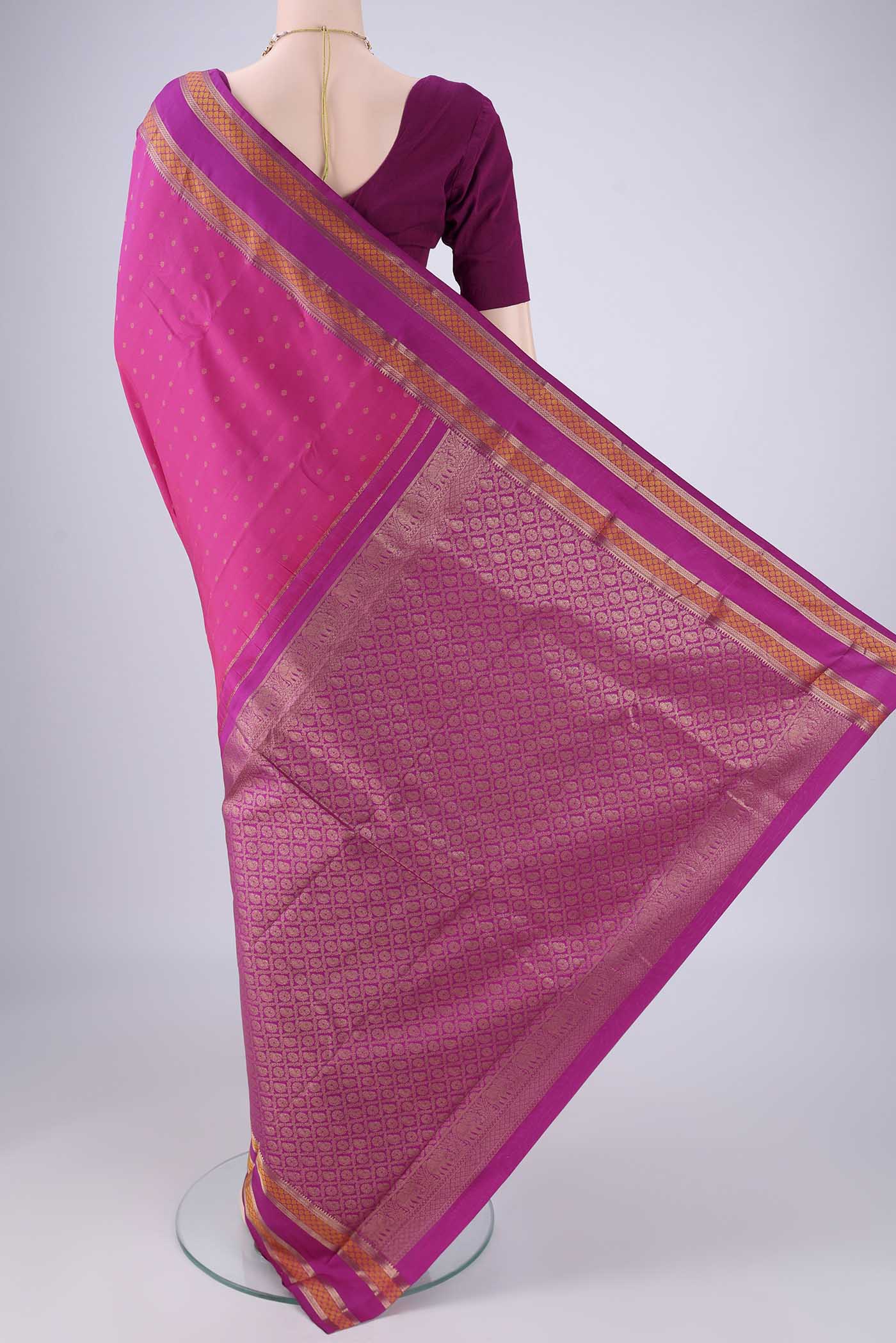 Flat view of Dark Pink Kanchipuram Silk Saree with Zari Butta on the body and Zari Border. 