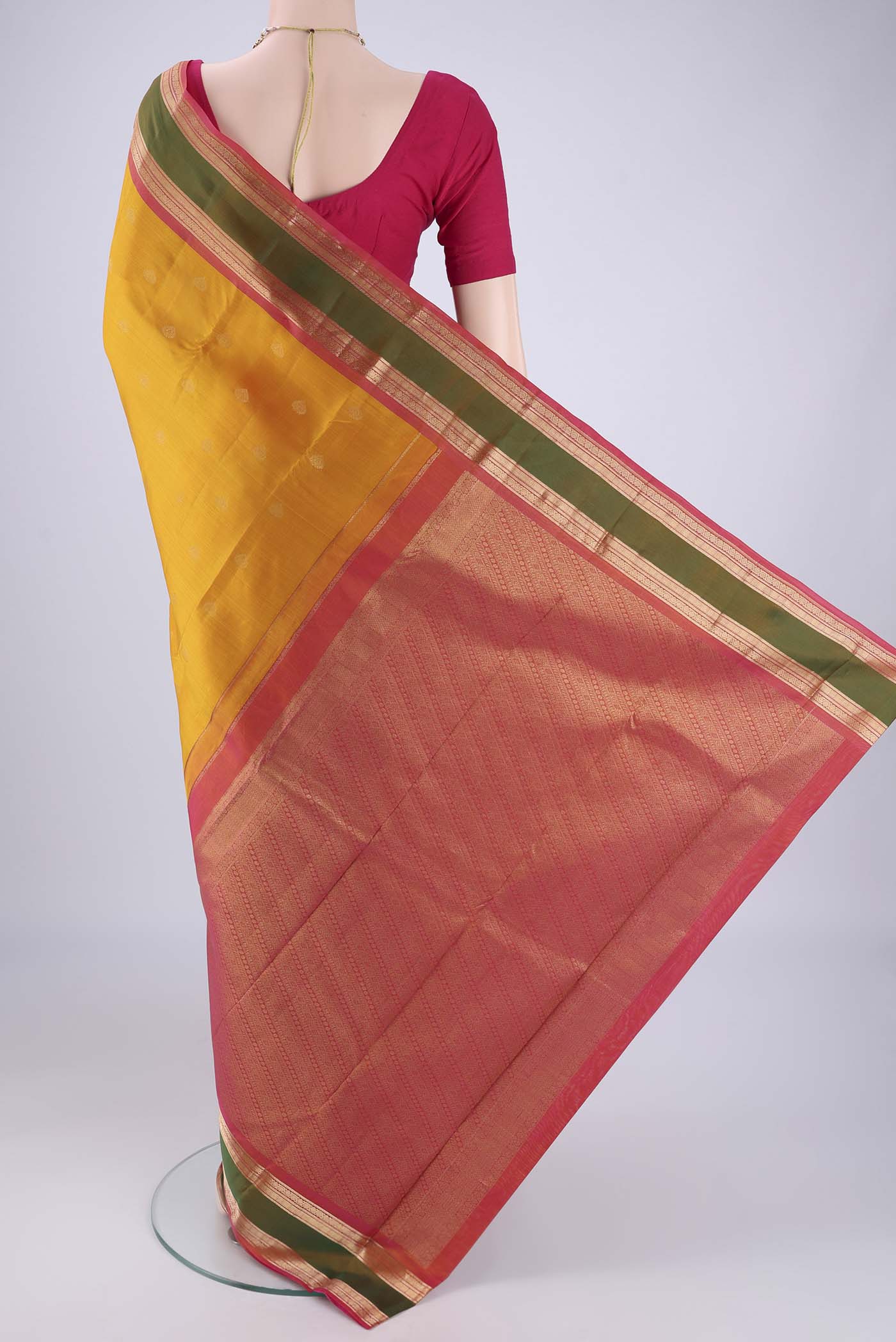 Flat view of Mustard Kanchipuram Silk Saree with Zari Butta on the body and Zari Border. 