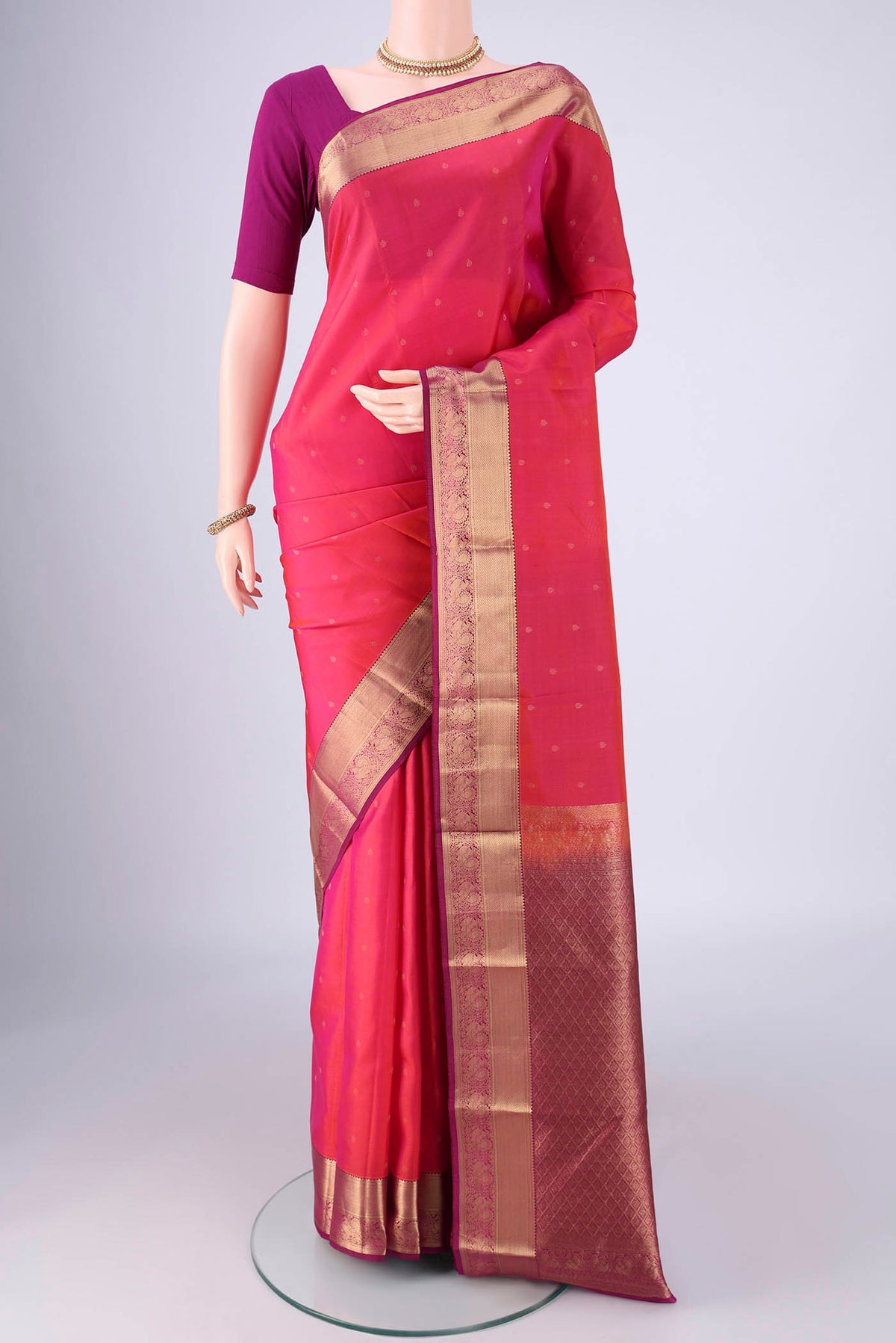 Pink Kanchipuram Silk Saree with Zari Butta on the body and Zari Border.  displayed on a mannequin