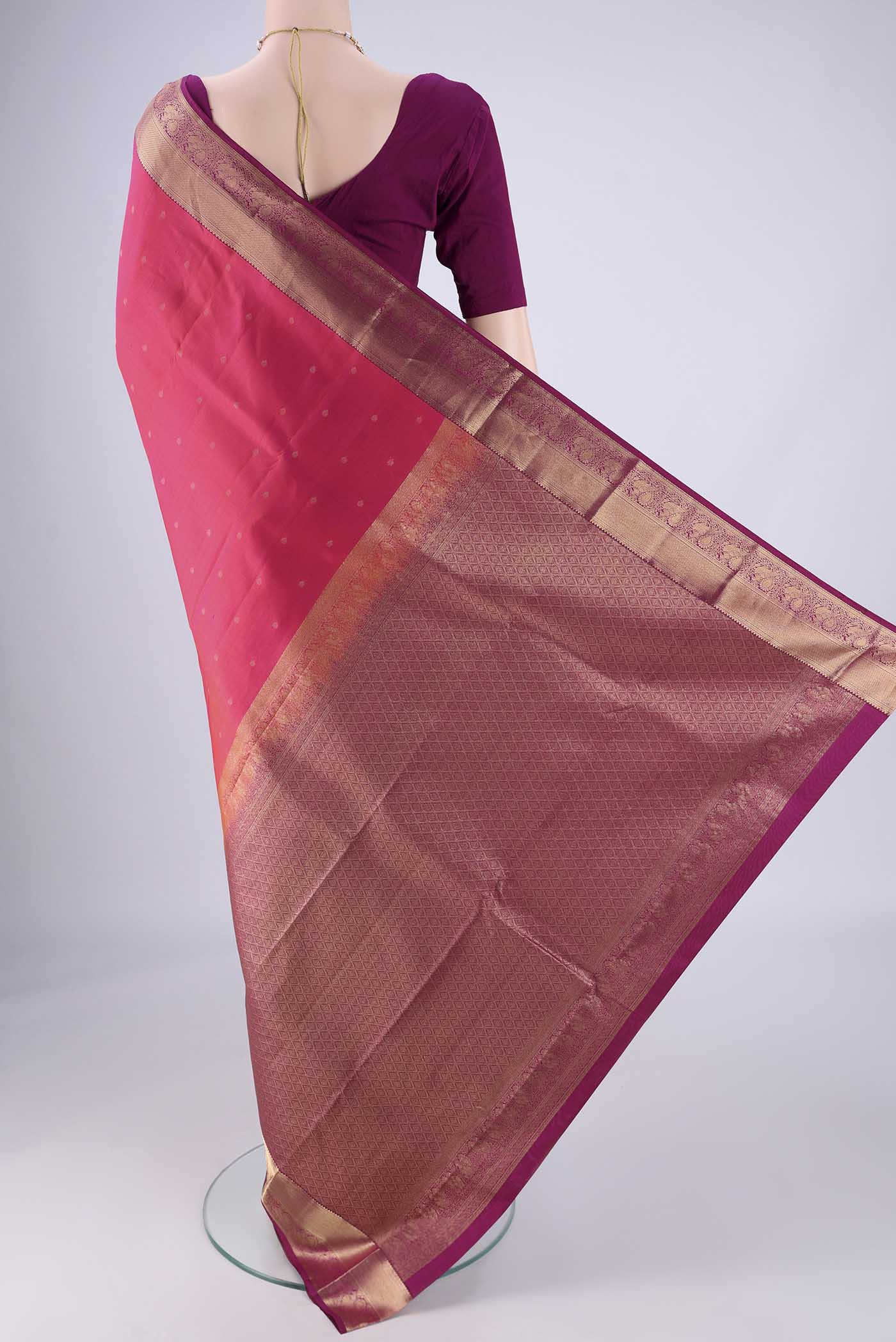 Flat view of Pink Kanchipuram Silk Saree with Zari Butta on the body and Zari Border. 