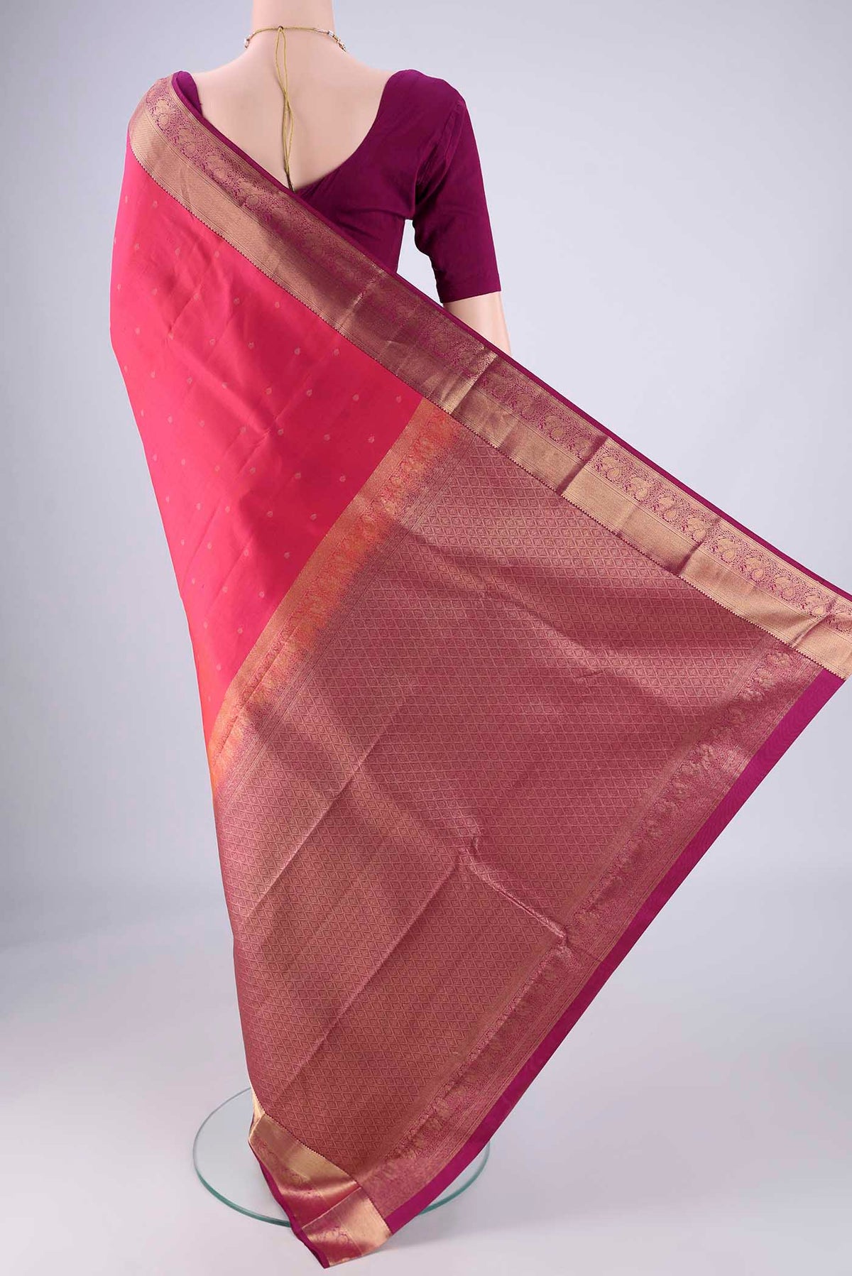 Flat view of Pink Kanchipuram Silk Saree with Zari Butta on the body and Zari Border. 