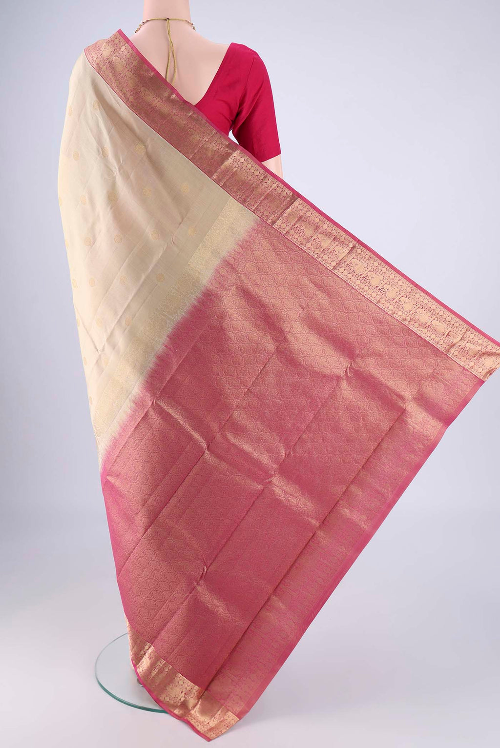 Flat view of Beige Kanchipuram Silk Saree with Zari Butta on the body and Zari Border. 