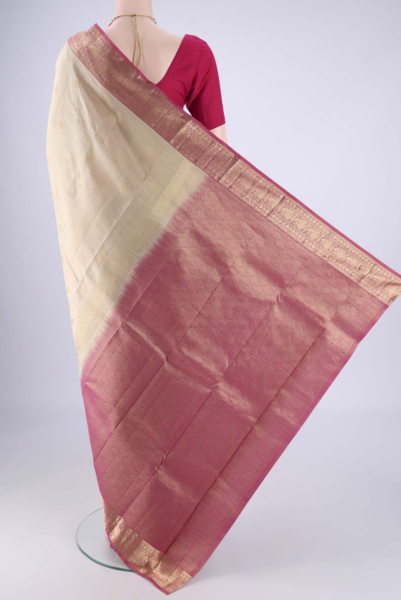 Flat view of Beige Kanchipuram Silk Saree with Zari Butta on the body and Zari Border. 