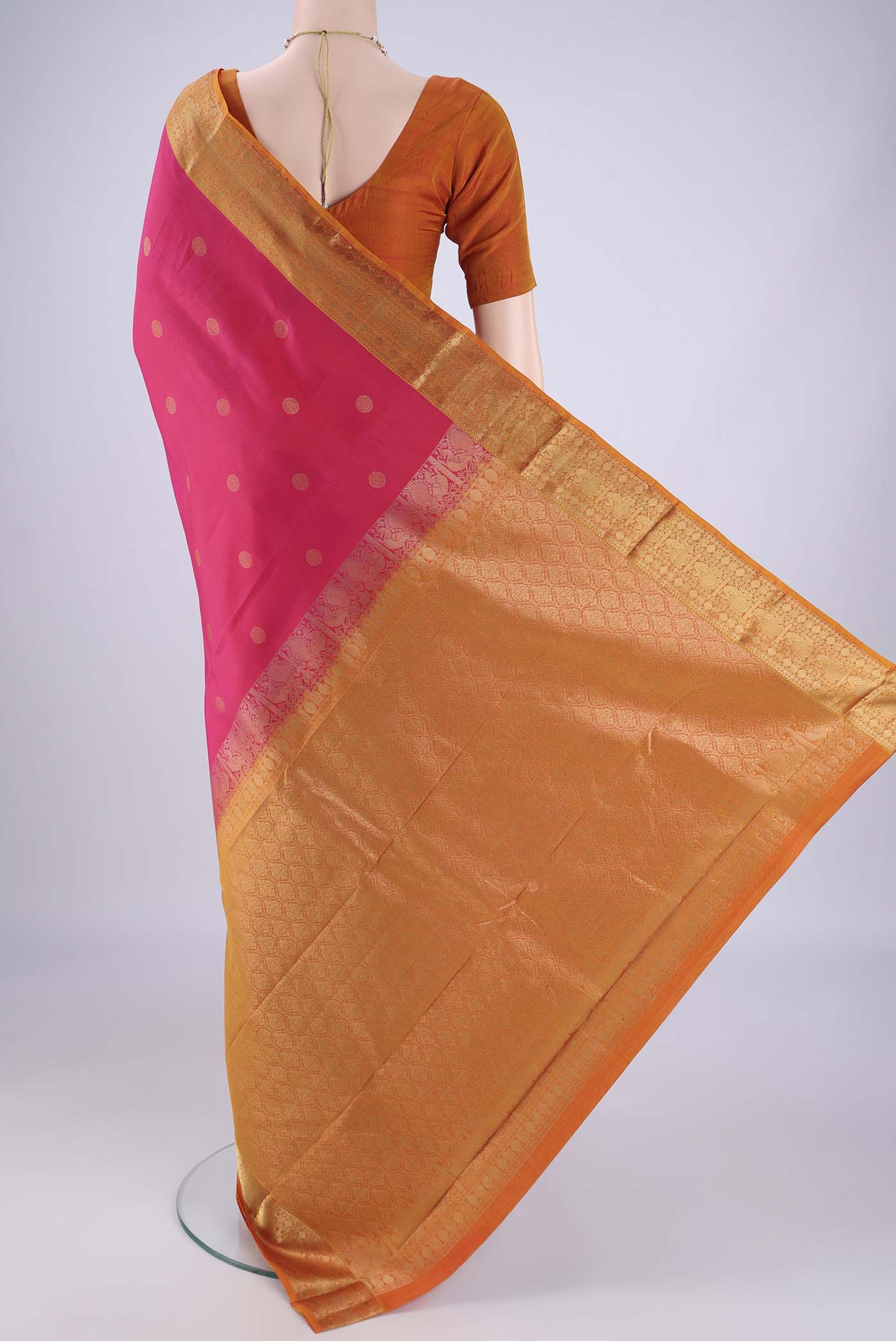 Flat view of Pink Kanchipuram Silk Saree with Zari Butta on the body and Zari Border. 