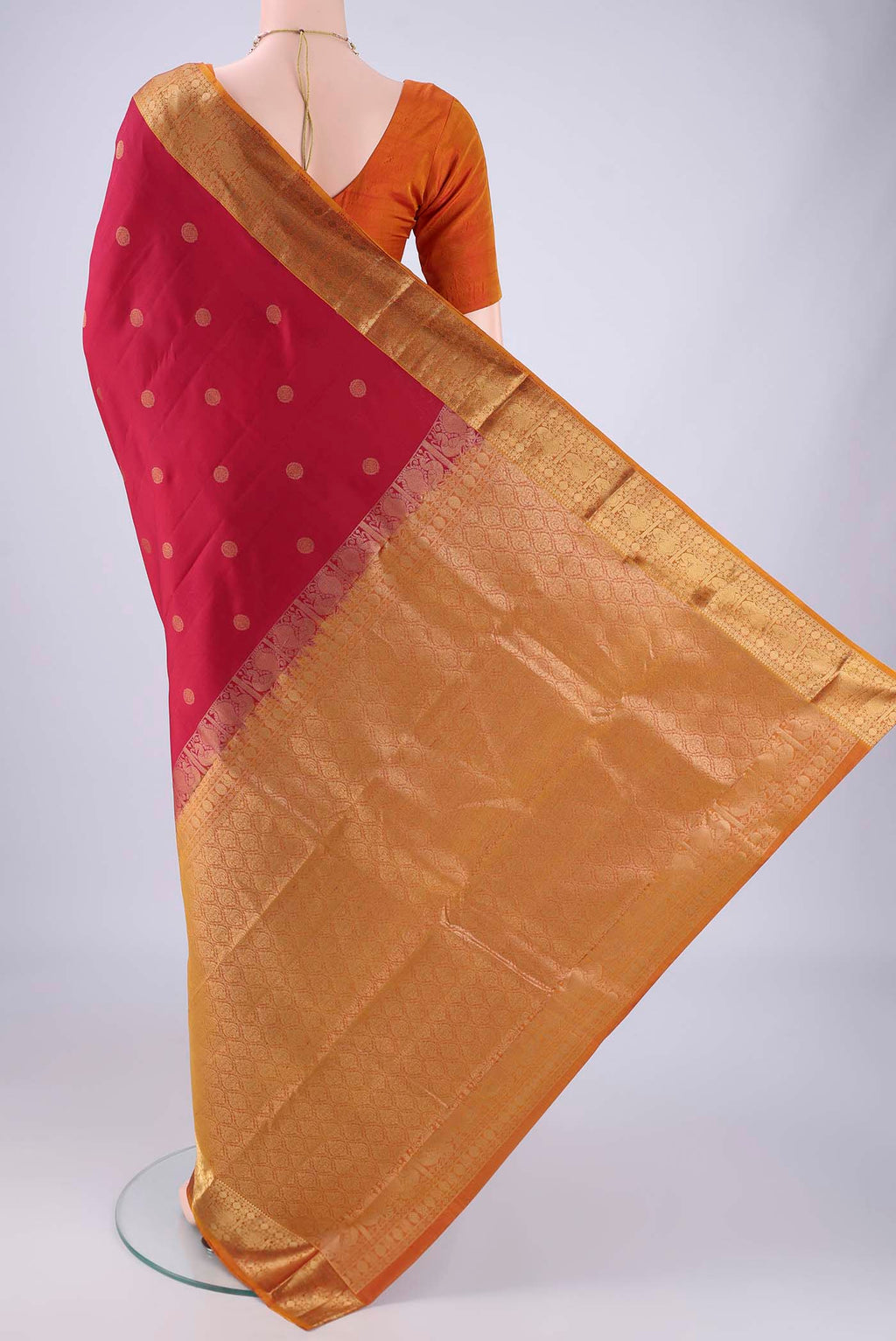 Flat view of Maroon Kanchipuram Silk Saree with Zari Butta on the body and Zari Border. 