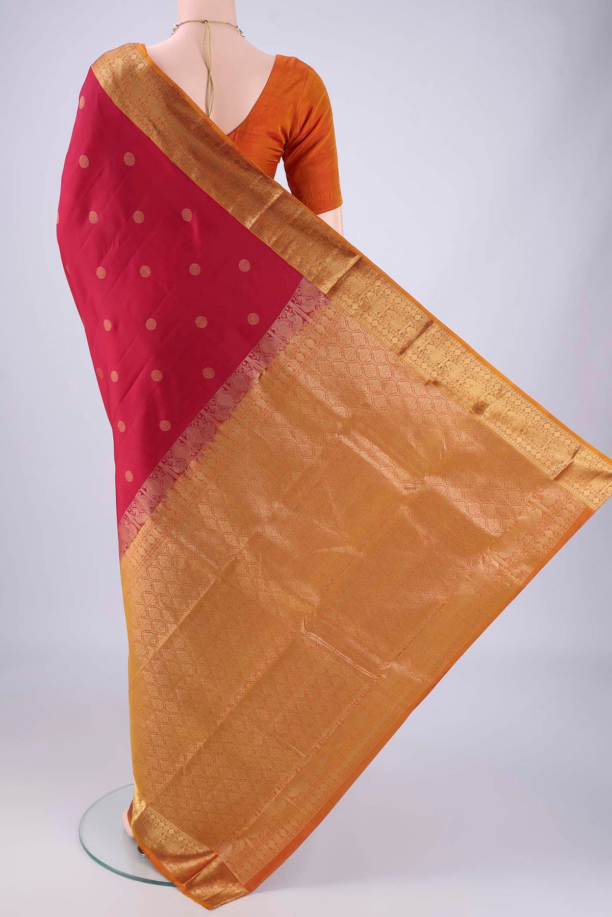 Flat view of Maroon Kanchipuram Silk Saree with Zari Butta on the body and Zari Border. 