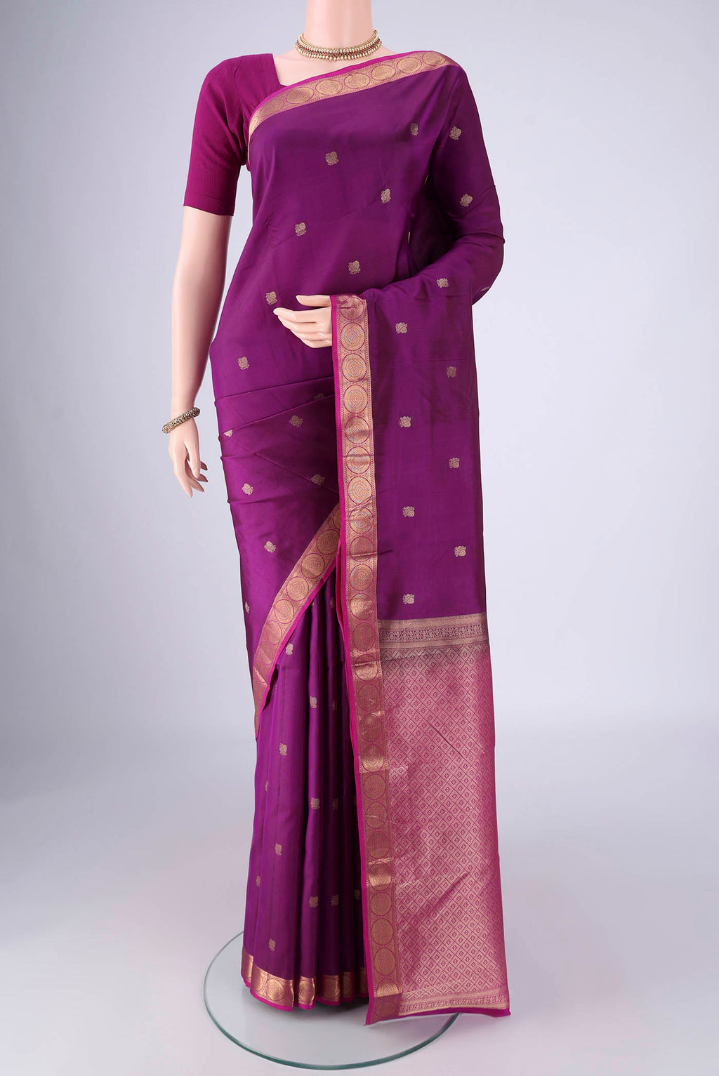 Purple Kanjivaram Silk Saree with Zari Butta on the body and Zari Border.  displayed on a mannequin