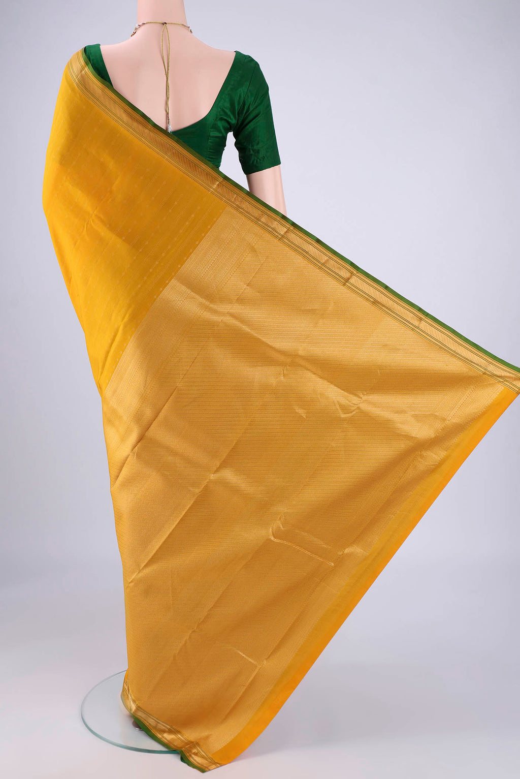 Flat view of Yellow Kanchipuram Silk Saree with Zari Butta on the body and Zari Border. 