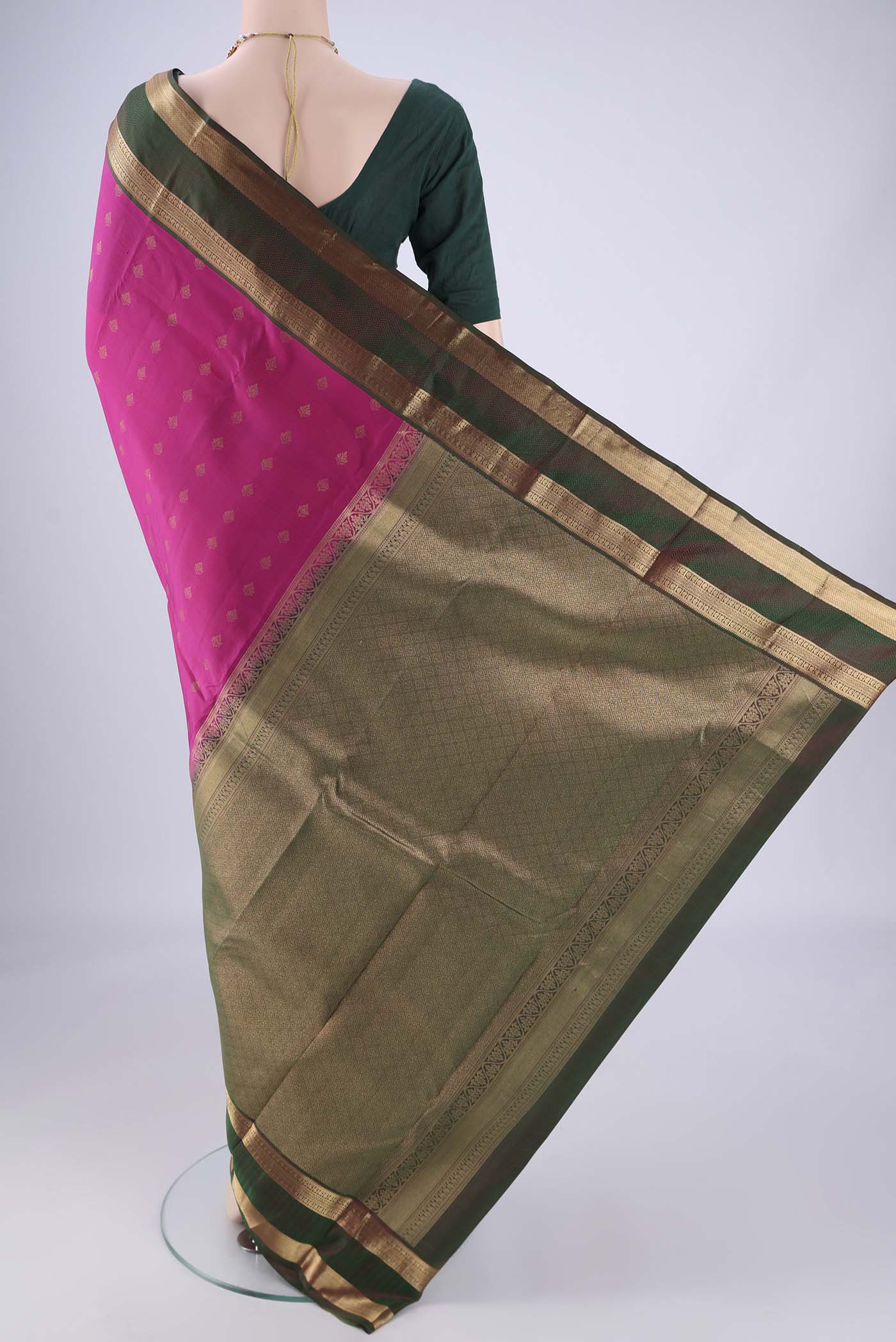 Flat view of Rani Pink Kanchipuram Silk Saree with Zari Butta on the body and Zari Border. 