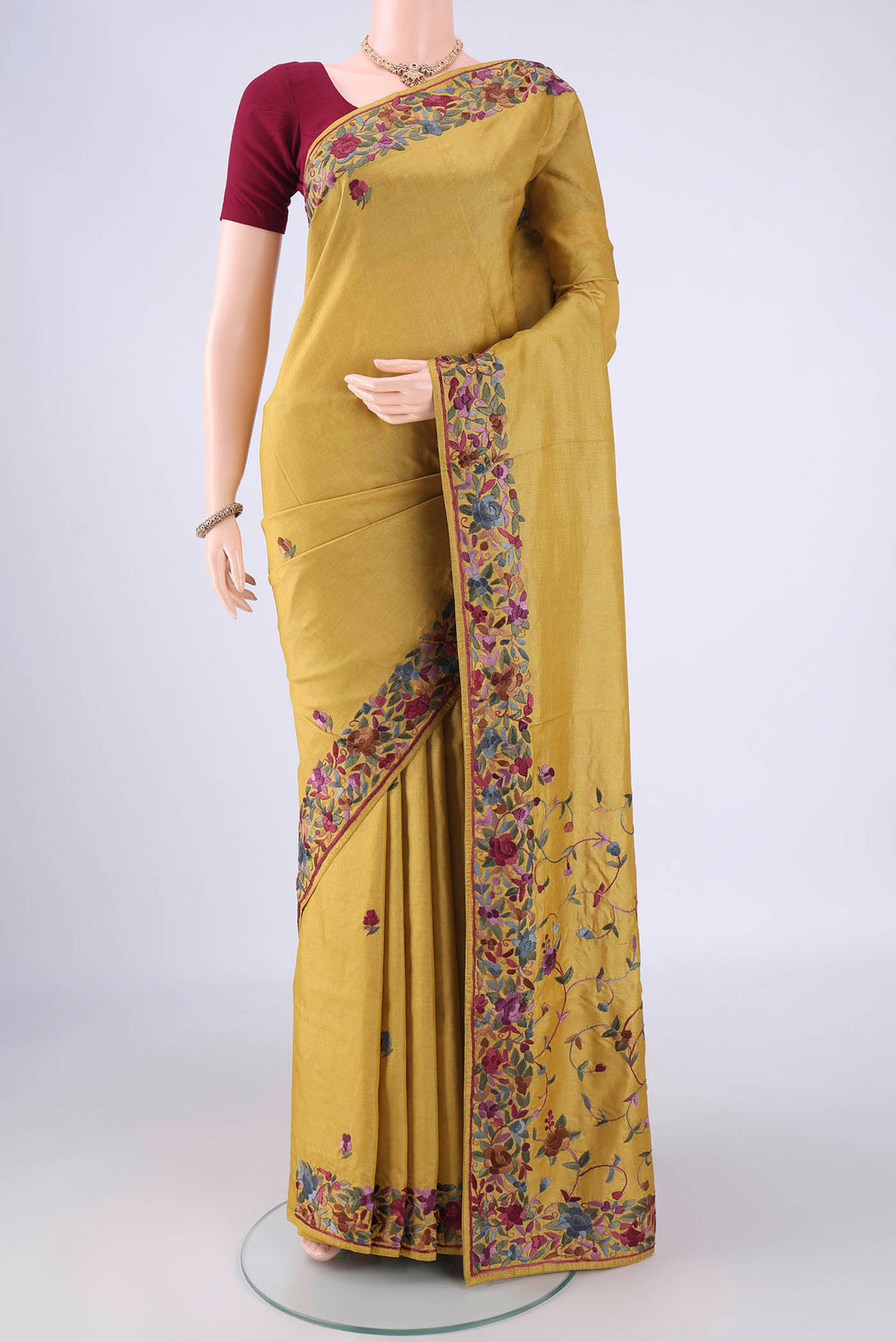 Golden Parsi Embroidery Saree with Embroidery on the body and Embroidery Border.  displayed on a mannequin