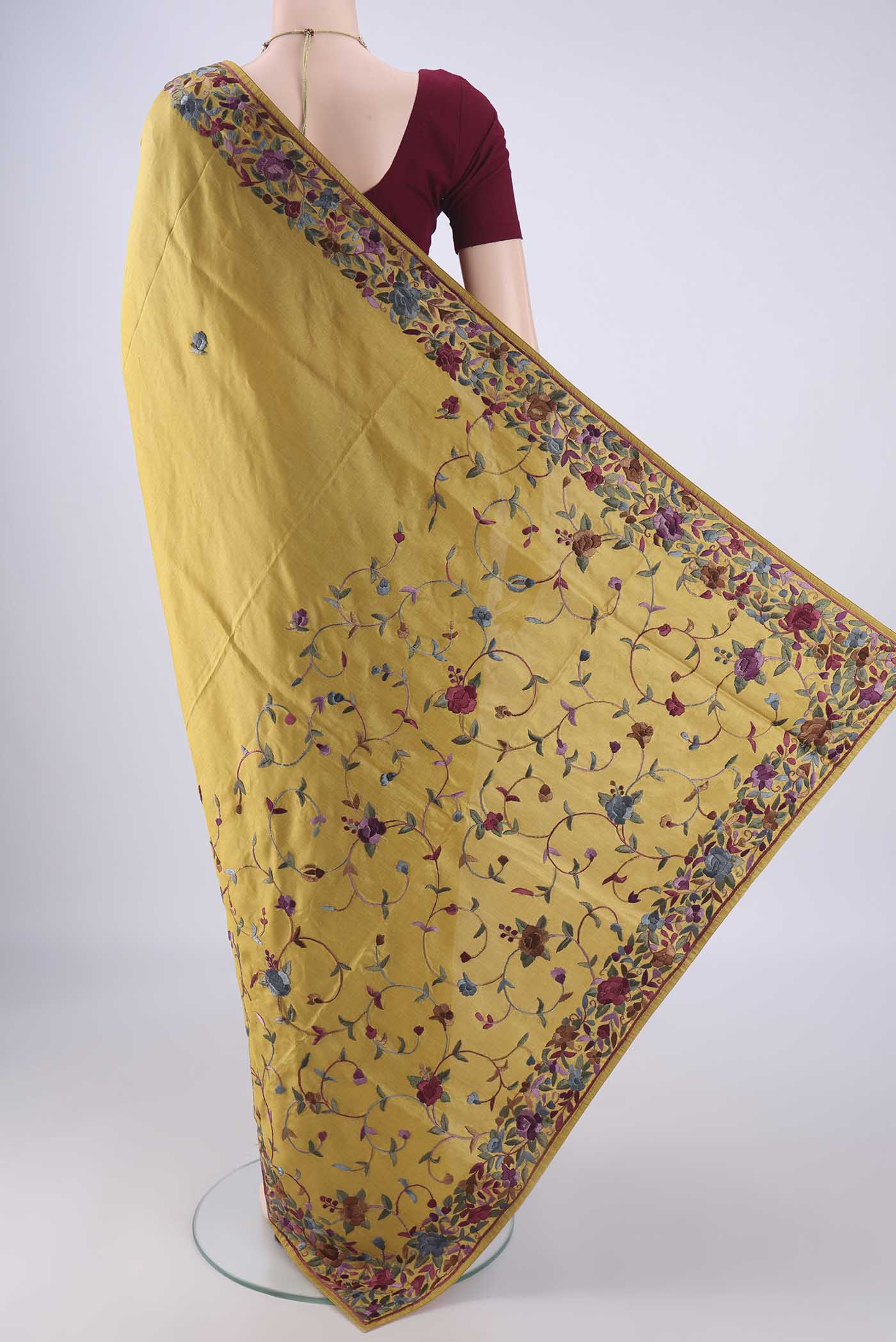 Flat view of Golden Parsi Embroidery Saree with Embroidery on the body and Embroidery Border. 