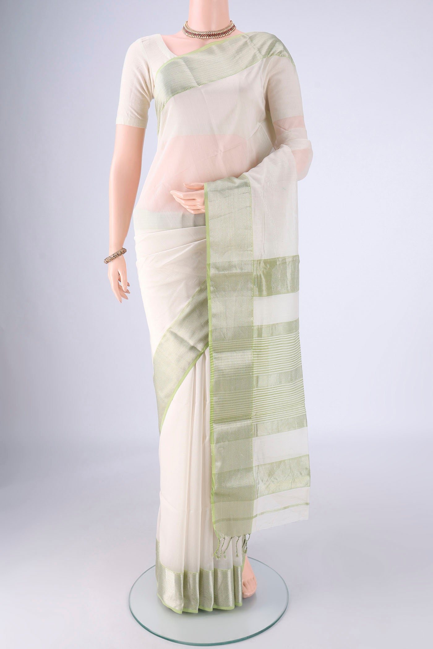 Off White Maheshwari Silk Cotton Saree with Plain Body and Zari Border.  displayed on a mannequin