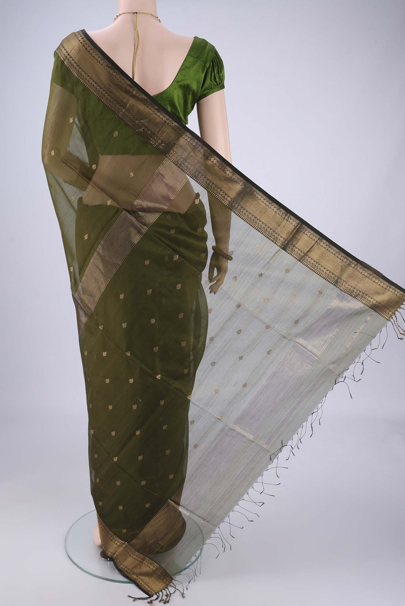 Flat view of Mehandi Green Maheshwari Silk Cotton Saree with Zari Butta on the body and Zari Border. 