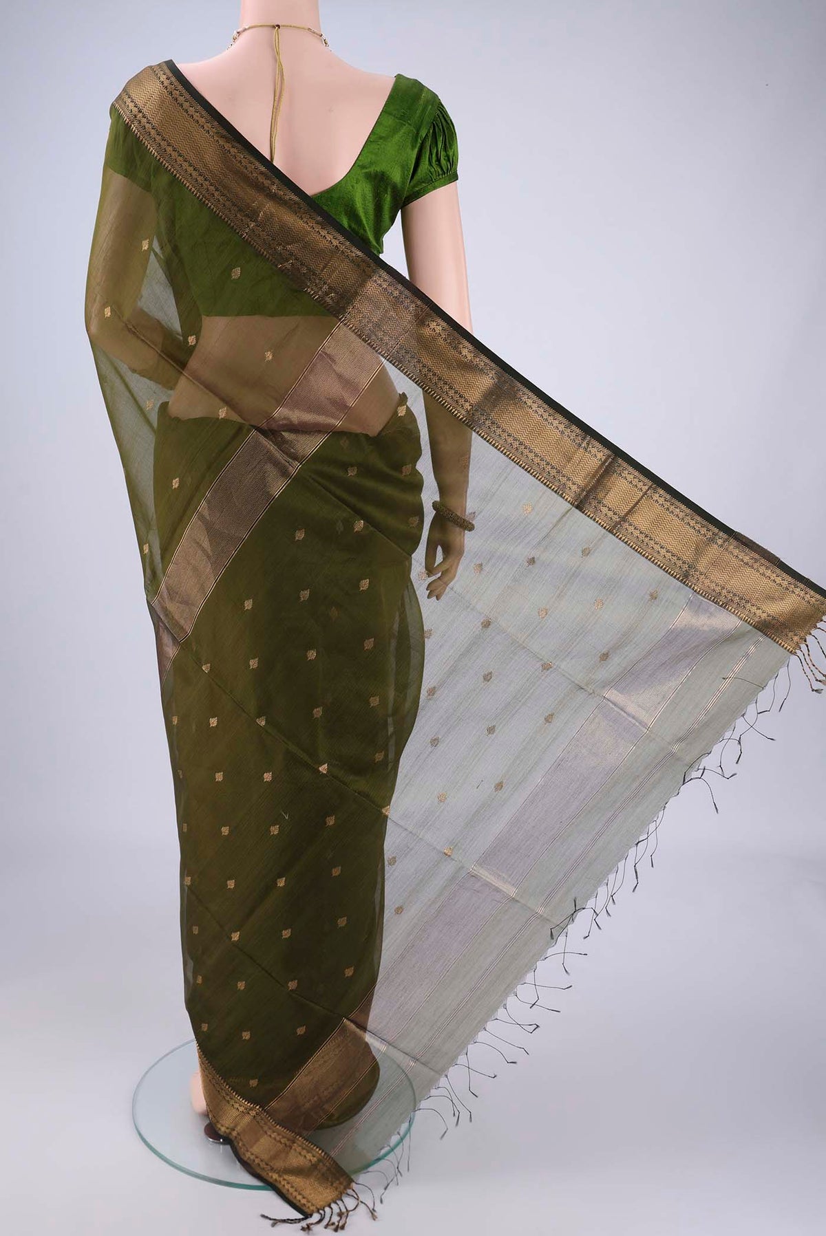 Flat view of Mehandi Green Maheshwari Silk Cotton Saree with Zari Butta on the body and Zari Border. 