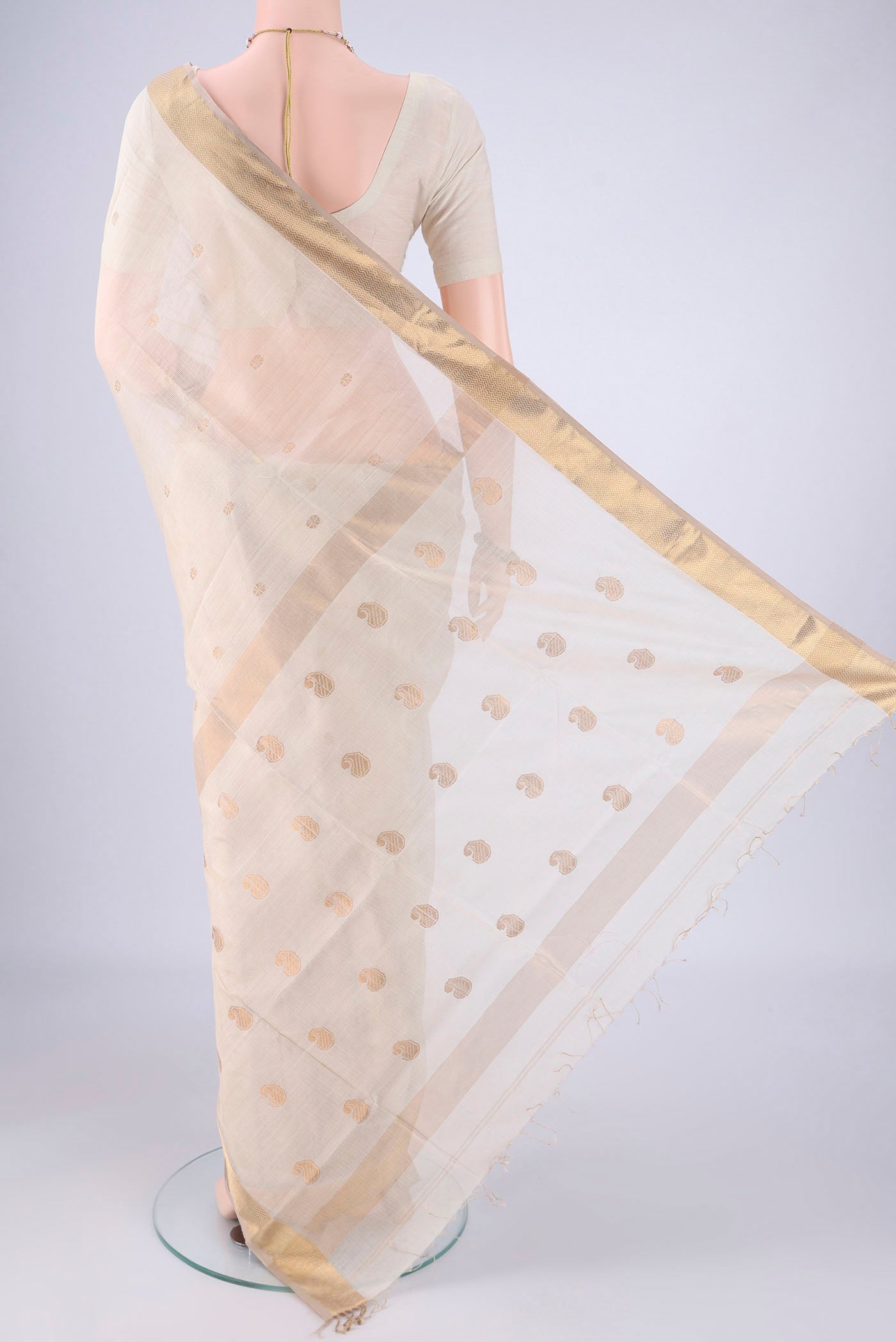 Flat view of Cream Maheshwari Silk Cotton Saree with Zari Butta on the body and Zari Border. 