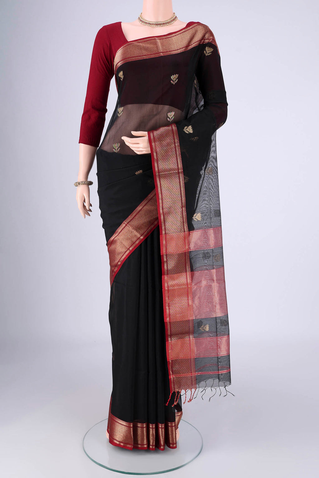 Black Maheshwari Silk Cotton Saree with Zari Butta on the body and Zari Border.  displayed on a mannequin