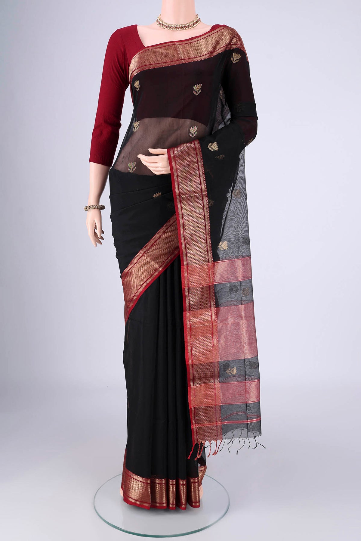 Black Maheshwari Silk Cotton Saree with Zari Butta on the body and Zari Border.  displayed on a mannequin