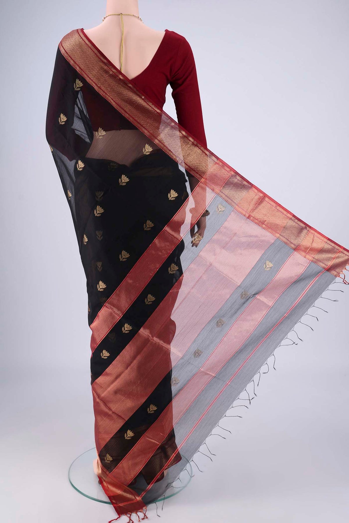 Flat view of Black Maheshwari Silk Cotton Saree with Zari Butta on the body and Zari Border. 