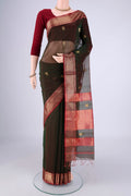 Bottle Green Dual Tone Maheshwari Silk Cotton Saree with Zari Butta on the body and Zari Border.  displayed on a mannequin
