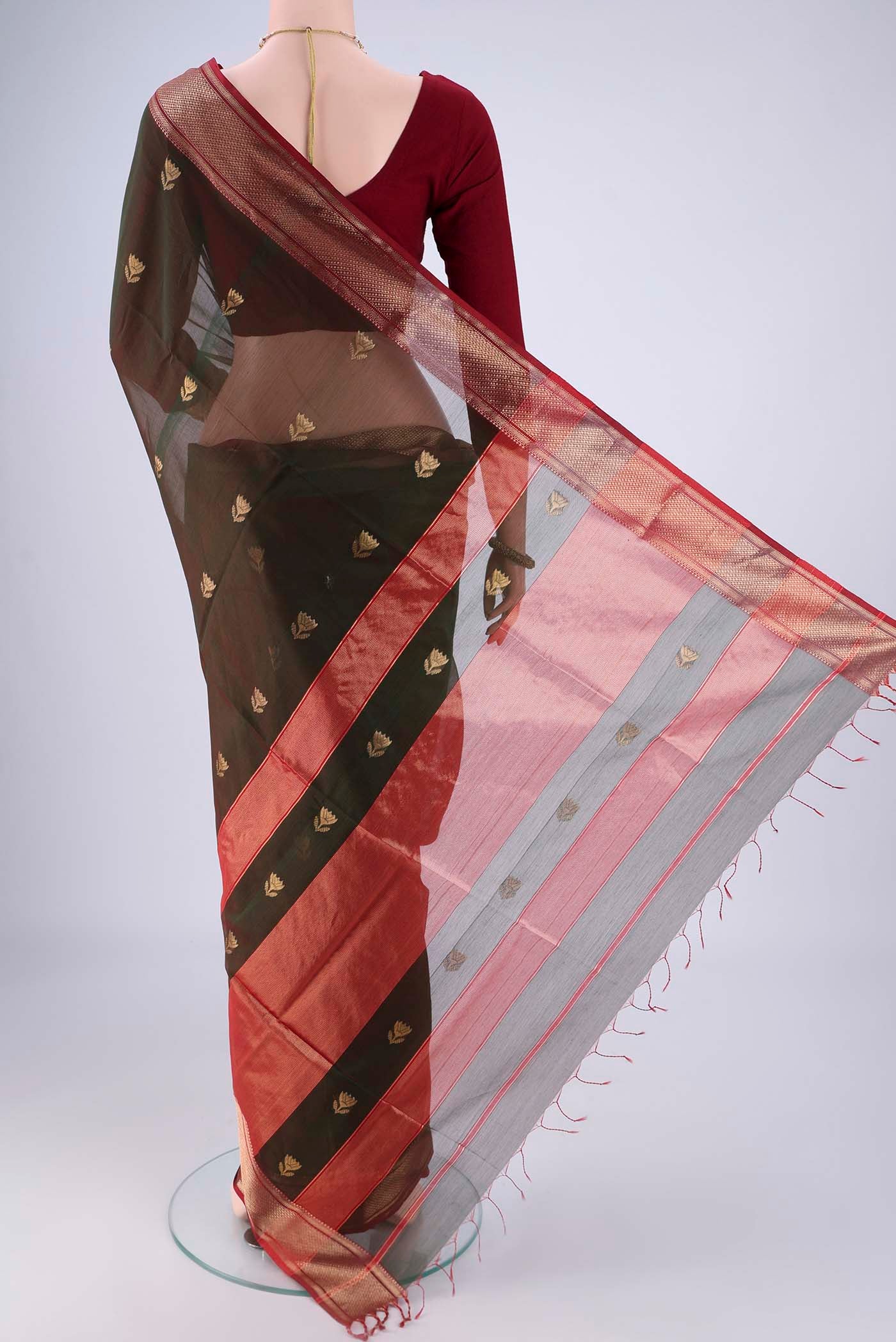 Flat view of Bottle Green Dual Tone Maheshwari Silk Cotton Saree with Zari Butta on the body and Zari Border. 