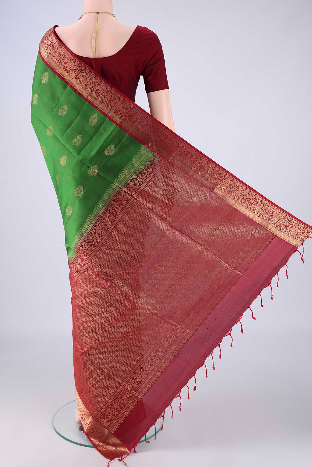 Flat view of Green Soft Silk Saree with Zari Butta on the body and Zari Border. 