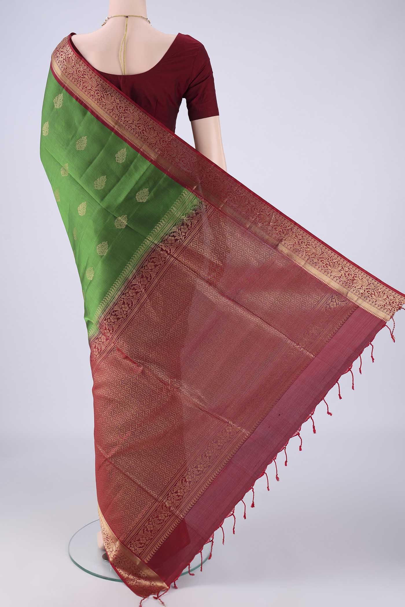Flat view of Green Soft Silk Saree with Zari Butta on the body and Zari Border. 