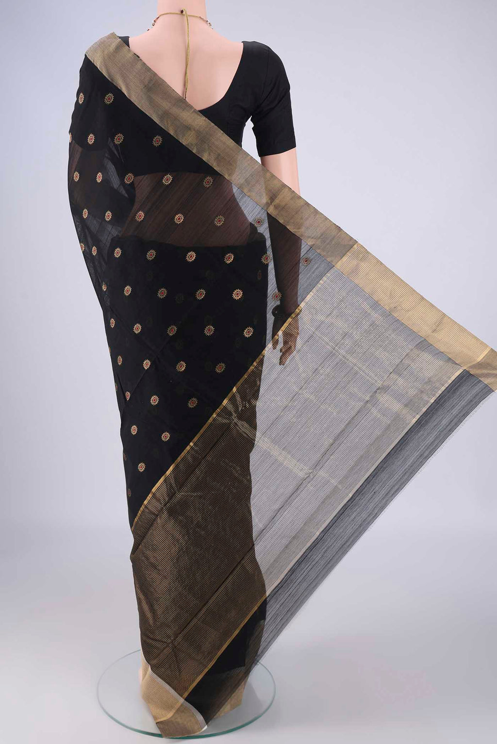 Flat view of Black Chanderi Silk Cotton Saree with Zari And Thread Butta on the body and Zari Border. 
