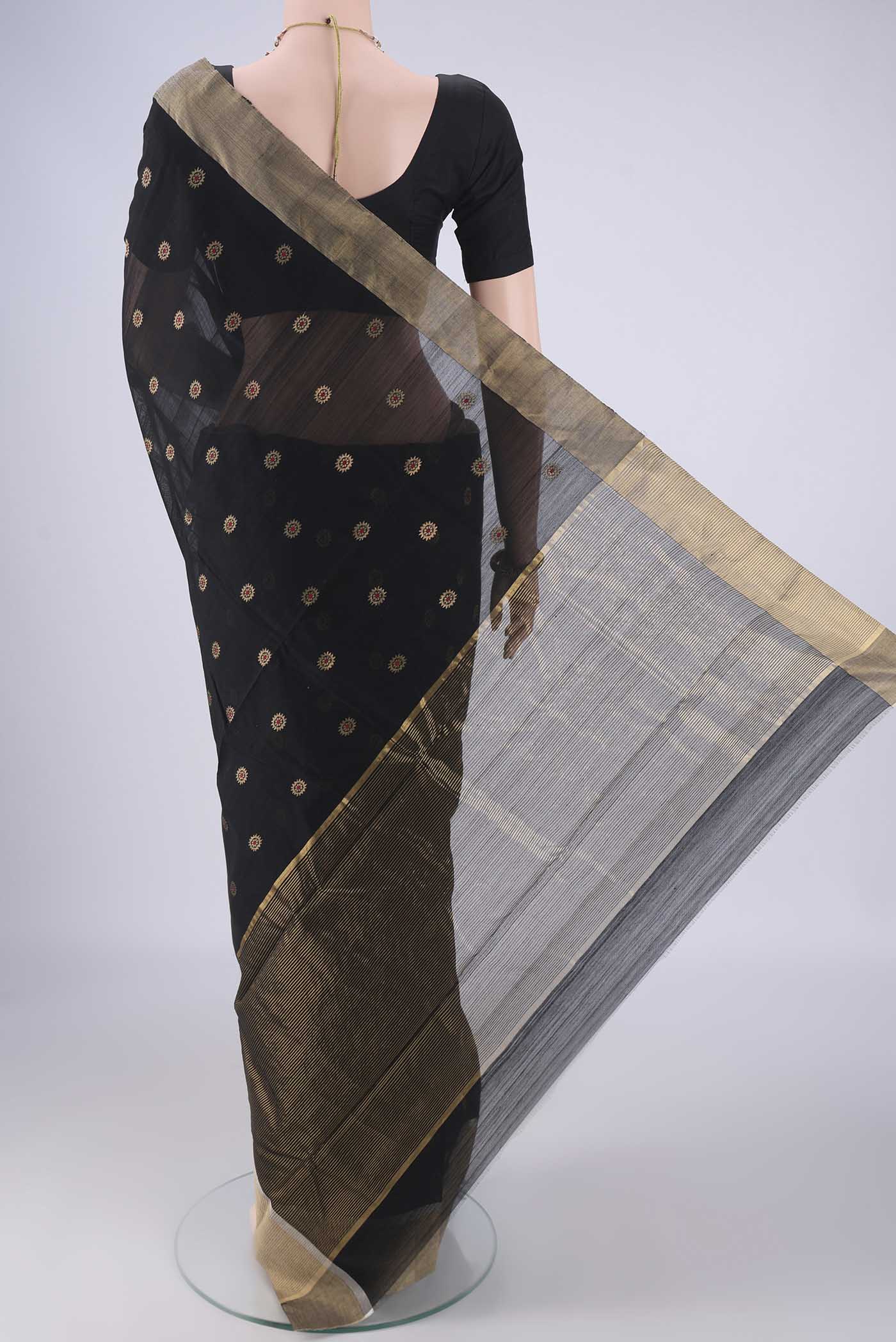 Flat view of Black Chanderi Silk Cotton Saree with Zari And Thread Butta on the body and Zari Border. 