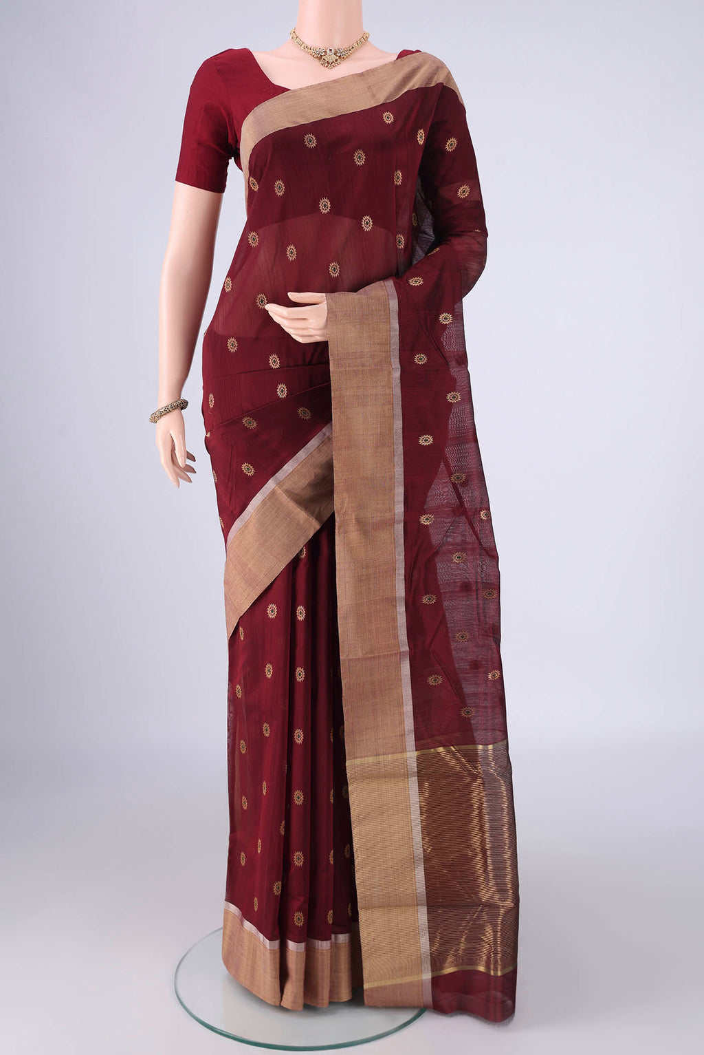 Coffee Brown Chanderi Silk Cotton Saree with Zari And Thread Butta on the body and Zari Border.  displayed on a mannequin