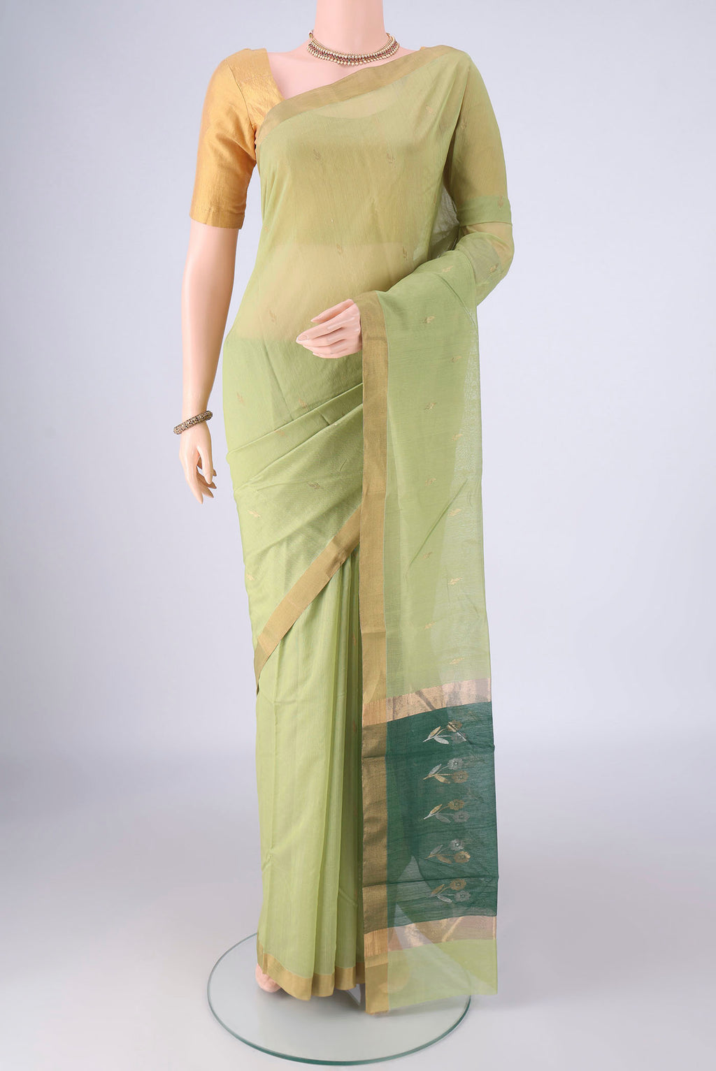 Light Green Chanderi Silk Cotton Saree with Zari Butta on the body and Zari Border.  displayed on a mannequin