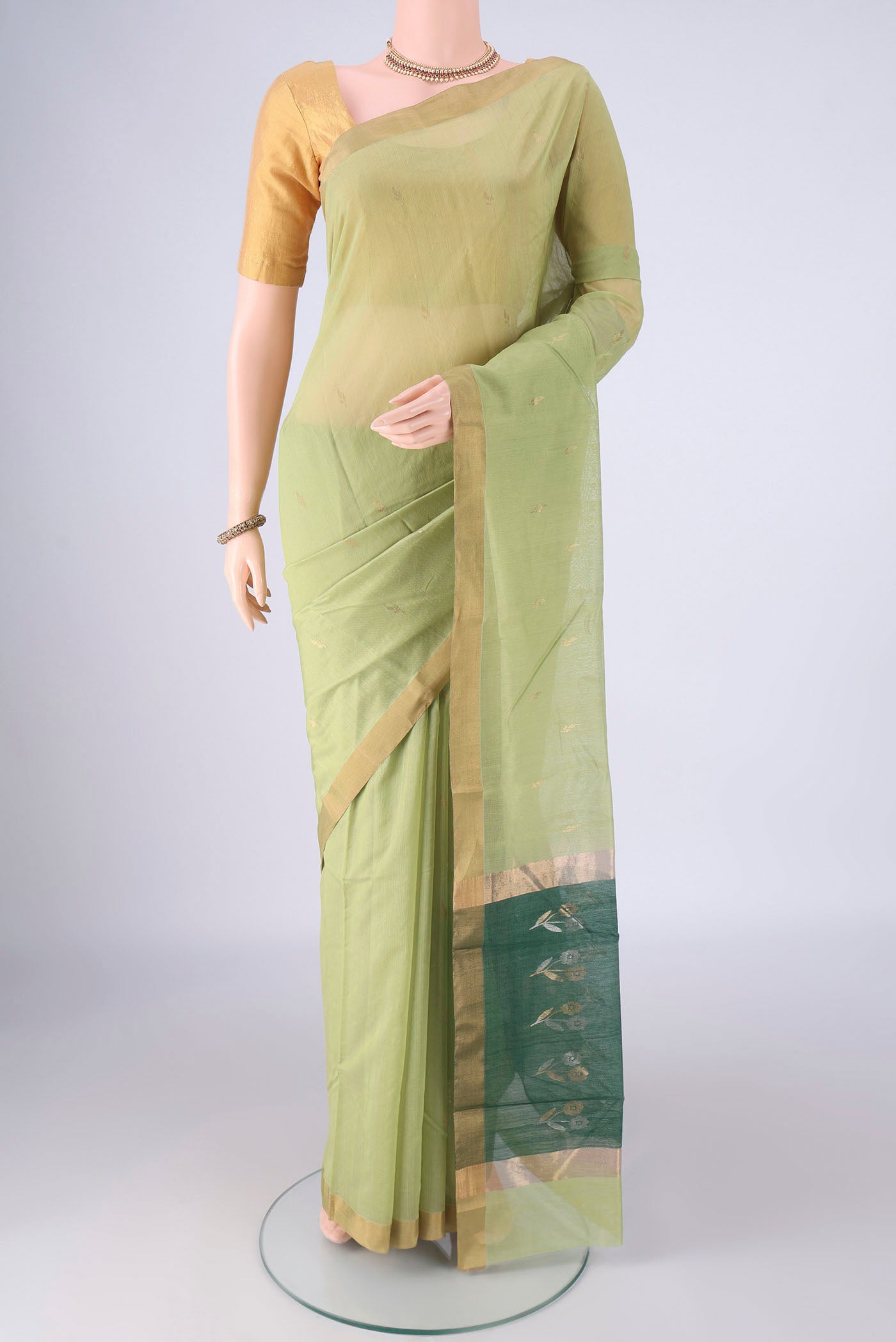 Light Green Chanderi Silk Cotton Saree with Zari Butta on the body and Zari Border.  displayed on a mannequin