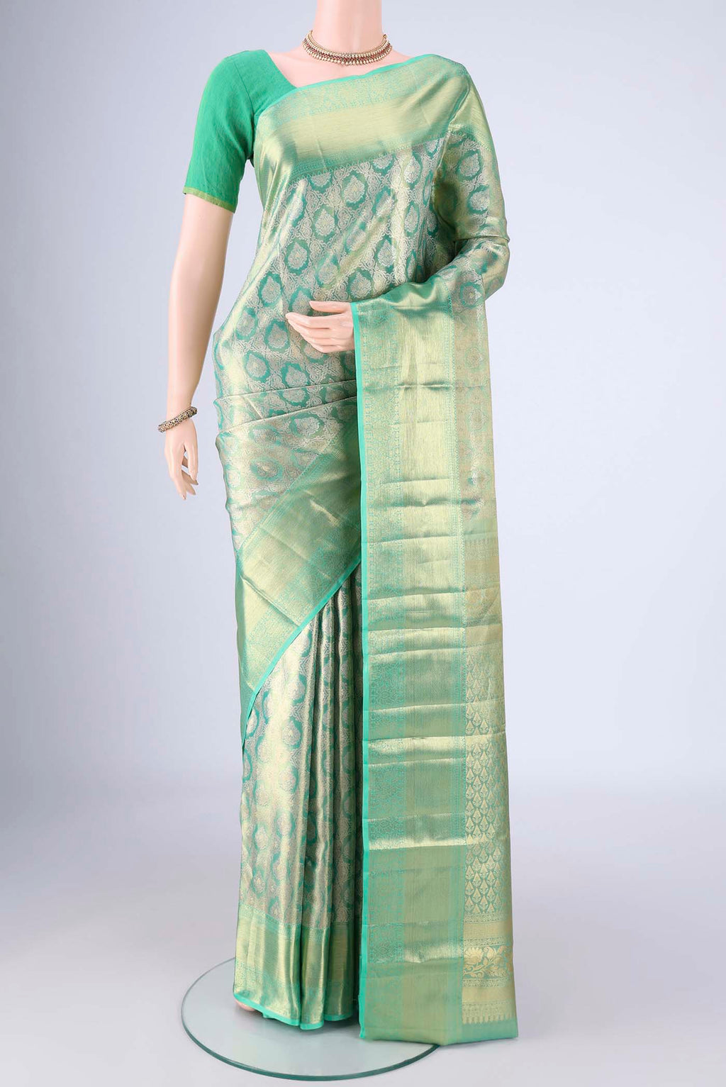 Sea Green Kanjivaram Tissue Silk Saree with Zari Brocade on the body and Zari Border.  displayed on a mannequin