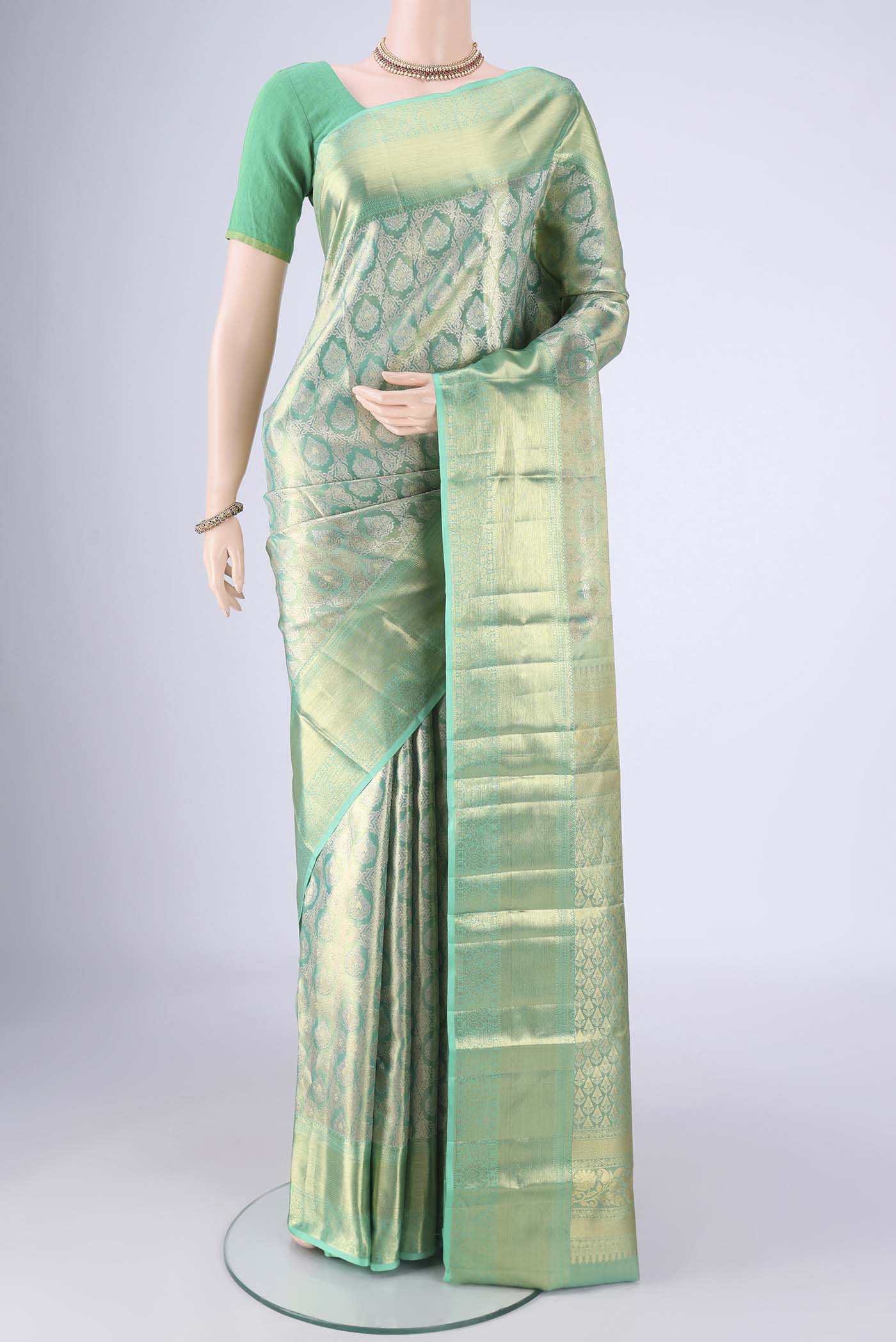 Sea Green Kanjivaram Tissue Silk Saree with Zari Brocade on the body and Zari Border.  displayed on a mannequin