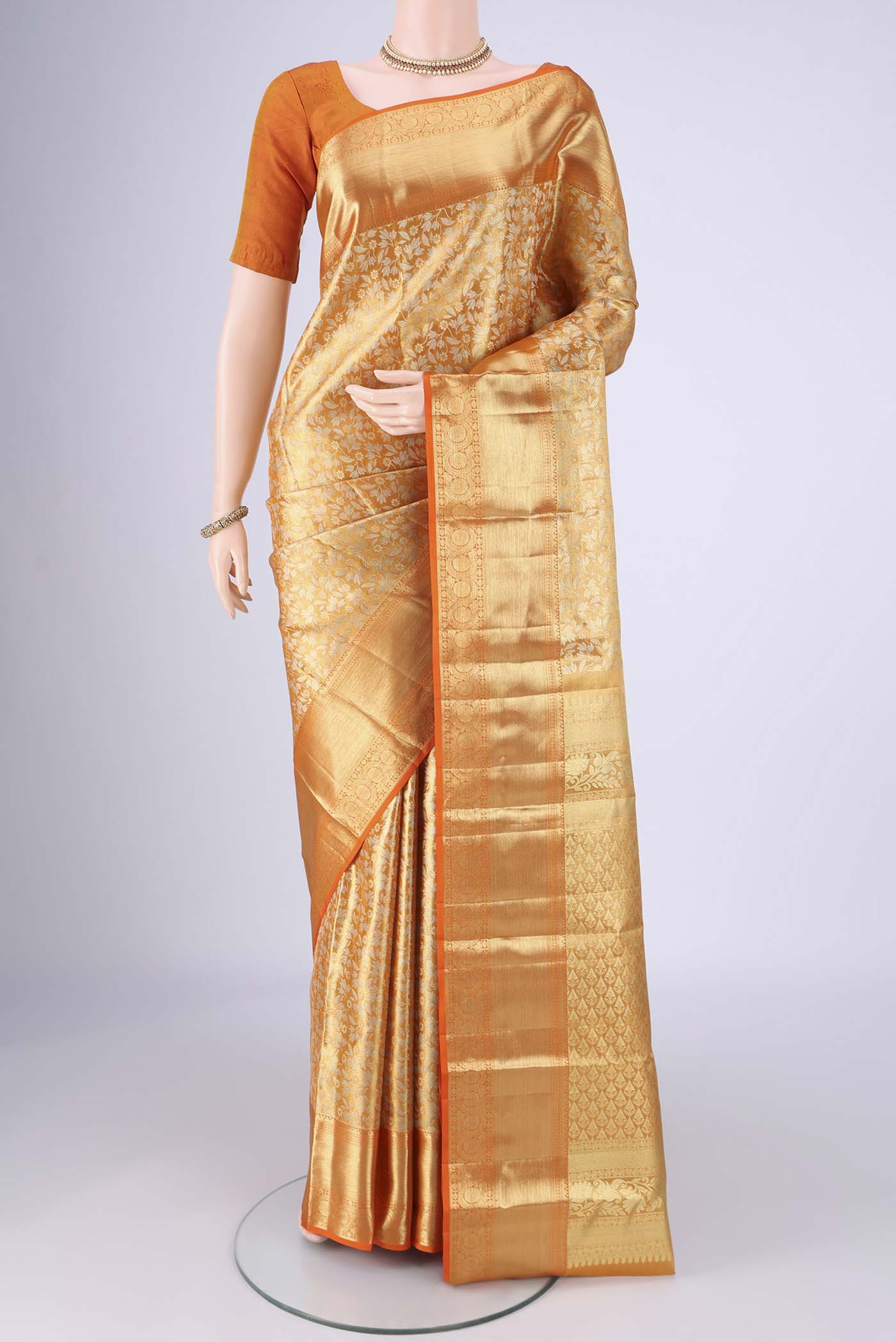 Golden Dual Tone Kanjivaram Tissue Silk Saree with Zari Brocade on the body and Zari Border.  displayed on a mannequin
