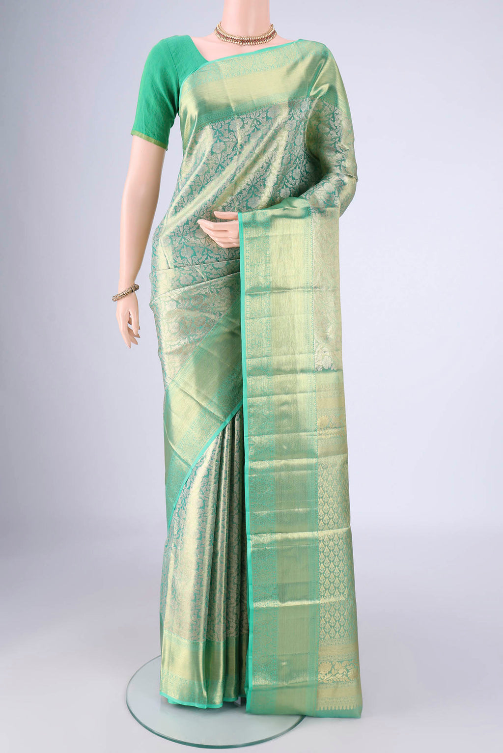 Sage Green Dual Tone Kanjivaram Tissue Silk Saree with Zari Brocade on the body and Zari Border.  displayed on a mannequin