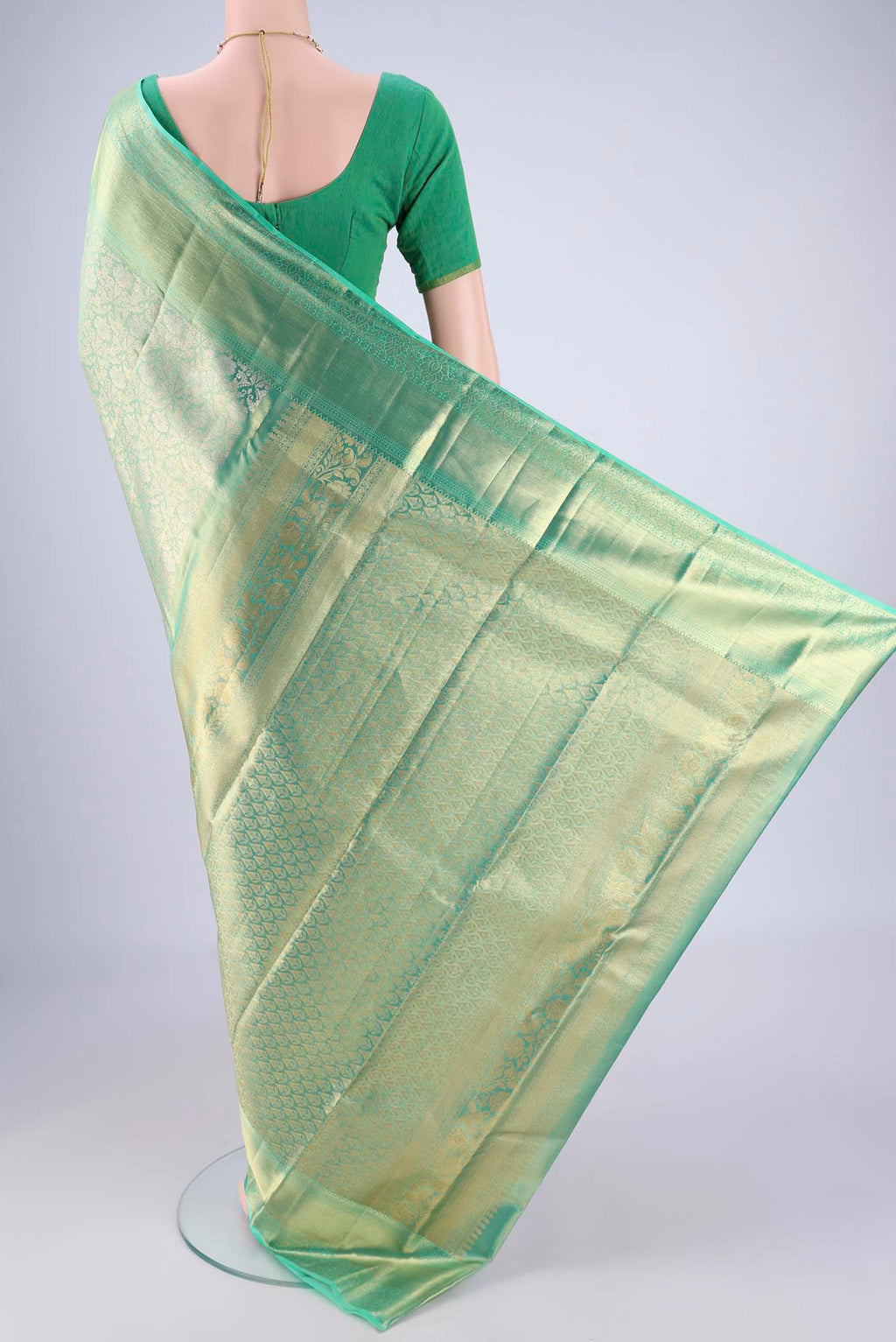 Flat view of Sage Green Dual Tone Kanjivaram Tissue Silk Saree with Zari Brocade on the body and Zari Border. 