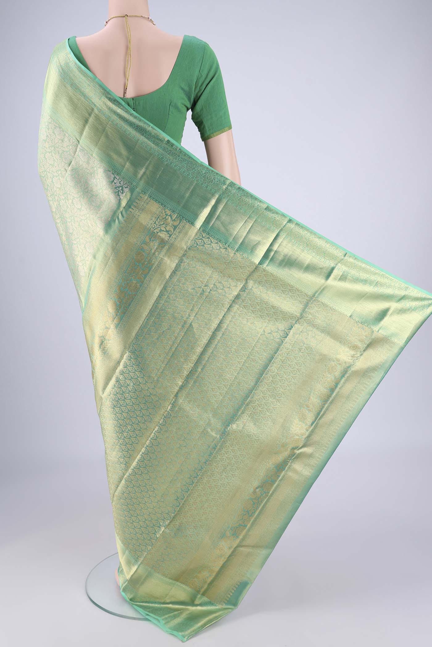 Flat view of Sage Green Dual Tone Kanjivaram Tissue Silk Saree with Zari Brocade on the body and Zari Border. 
