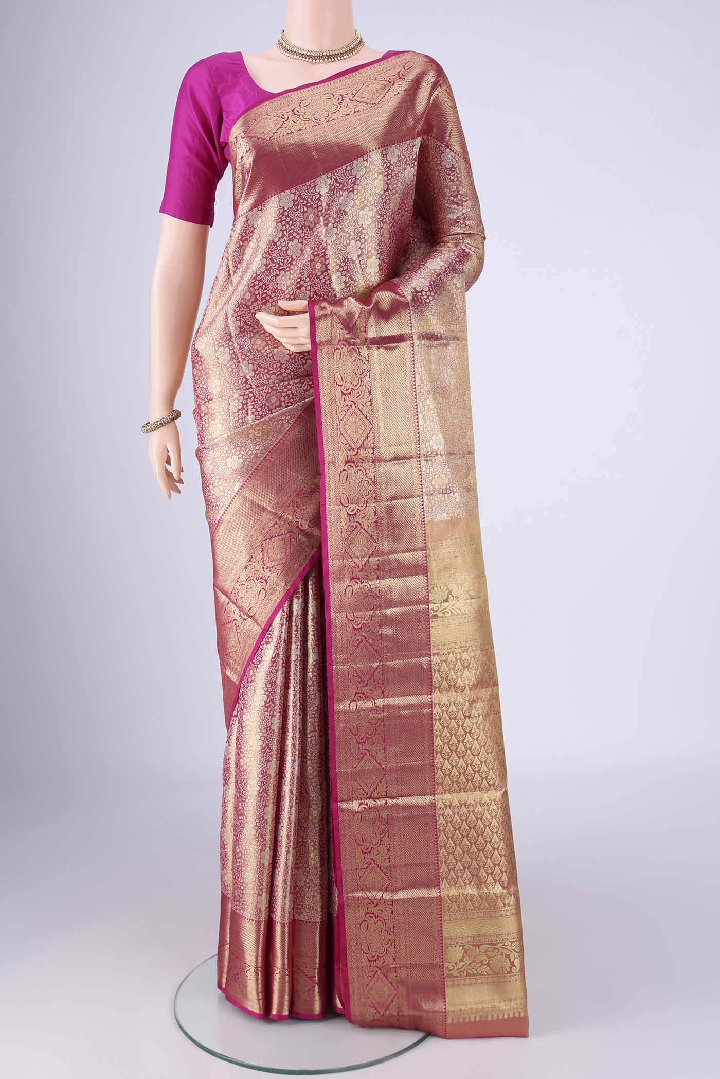 Rose Gold Dual Tone Kanjivaram Tissue Silk Saree with Zari Brocade on the body and Zari Border.  displayed on a mannequin
