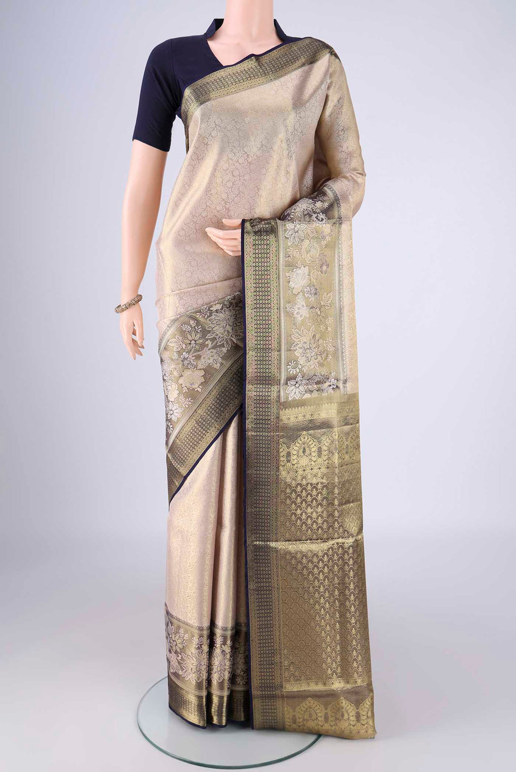 Golden Dual Tone Kanchipuram Tissue Silk Saree with Zari Brocade on the body and Zari Border.  displayed on a mannequin