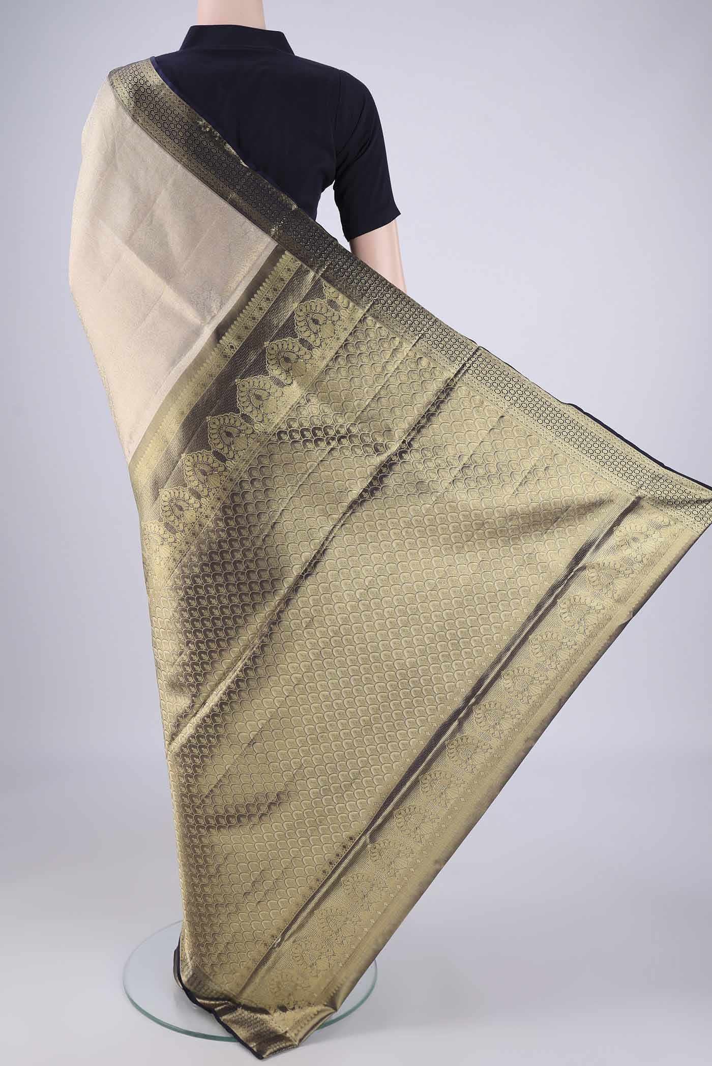 Flat view of Golden Dual Tone Kanchipuram Tissue Silk Saree with Zari Brocade on the body and Zari Border. 