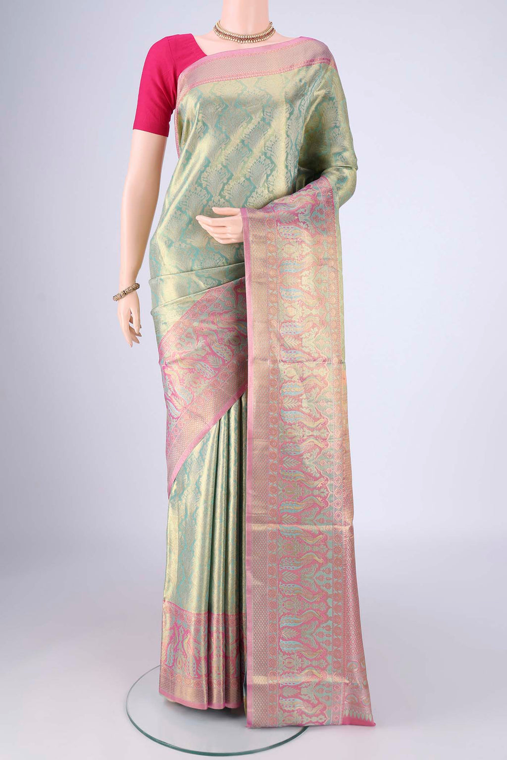 Sea Green Dual Tone Kanchipuram Tissue Silk Saree with Zari Brocade on the body and Zari Border.  displayed on a mannequin