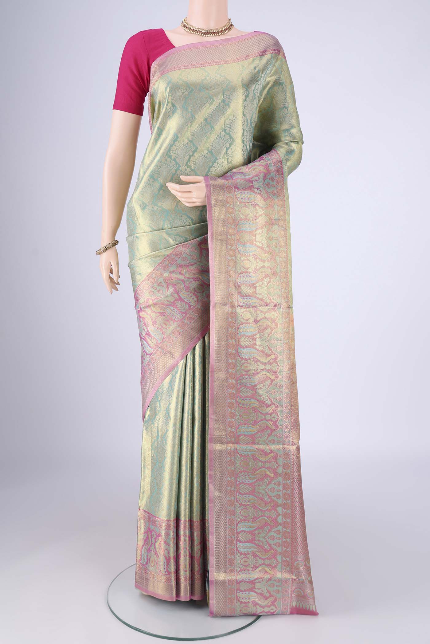 Sea Green Dual Tone Kanchipuram Tissue Silk Saree with Zari Brocade on the body and Zari Border.  displayed on a mannequin