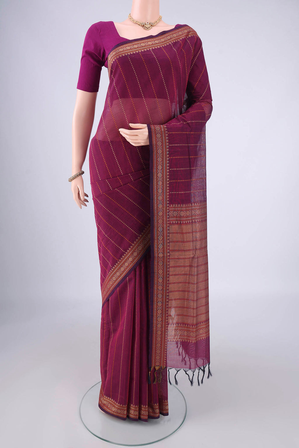Magenta Coimbatore Cotton Saree with Stripes on the body and Thread Border.  displayed on a mannequin