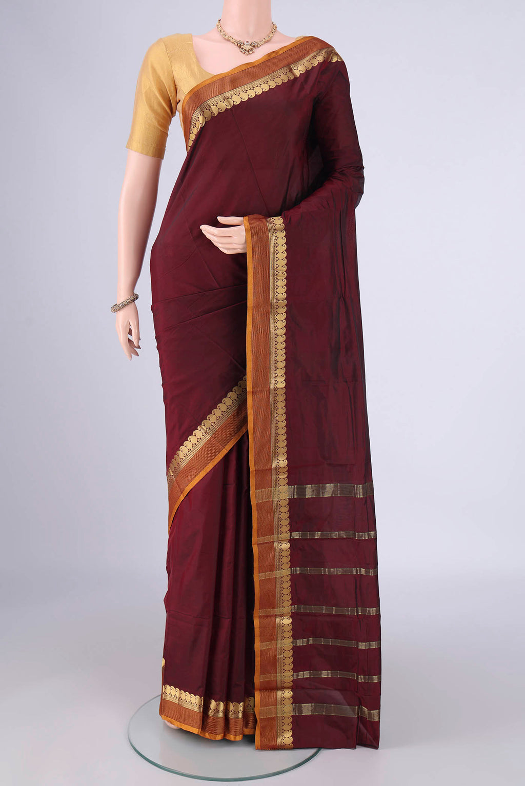 Maroon Blended Bangalore Silk Saree with Plain Body and Zari Border.  displayed on a mannequin