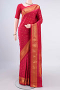 Pure Silk Coral Gadwal Saree with Zari Butta on the body and Zari Border.  displayed on a mannequin
