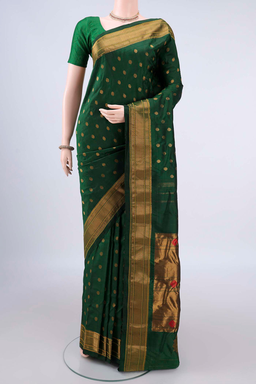 Pure Silk Bottle Green Gadwal Saree with Zari Butta on the body and Zari Border.  displayed on a mannequin